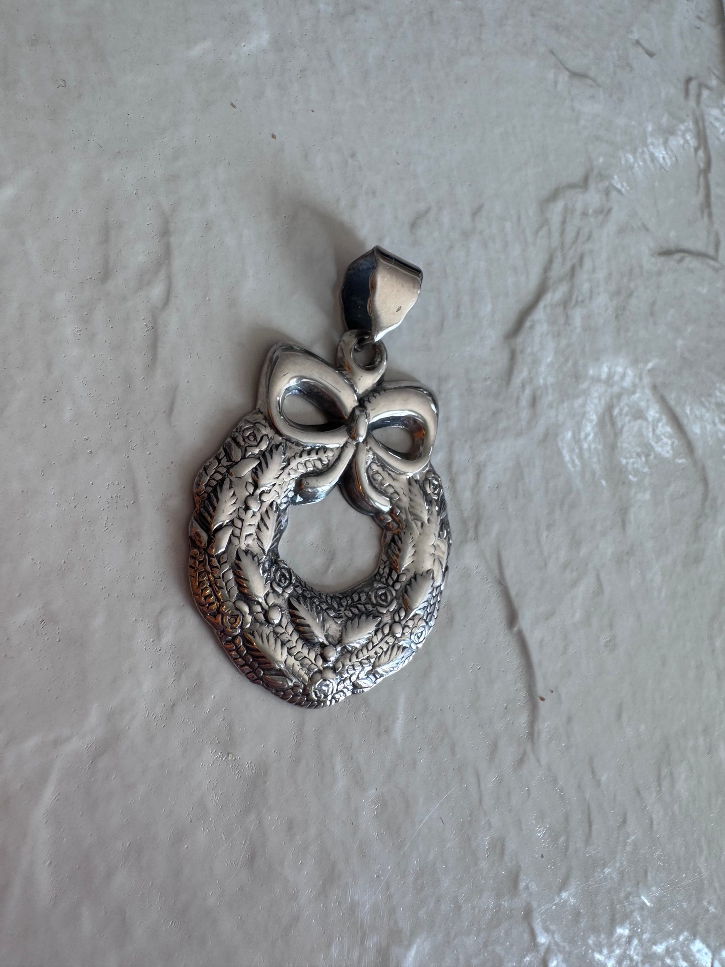 Estate 925 sterling silver Christmas wreath pendant from Thailand with detailed roses leaves and bow showing intricate Thai craftsmanship