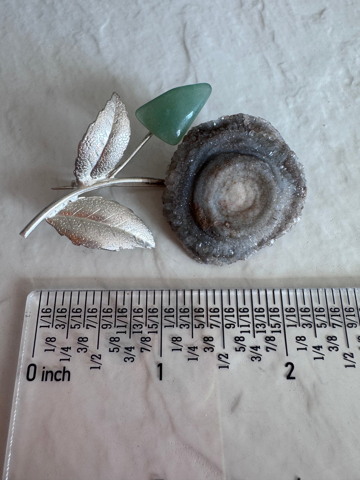 Estate Soviet silver flower brooch with natural druzy geode center and green aventurine bud, showing textured leaves and crystalline details