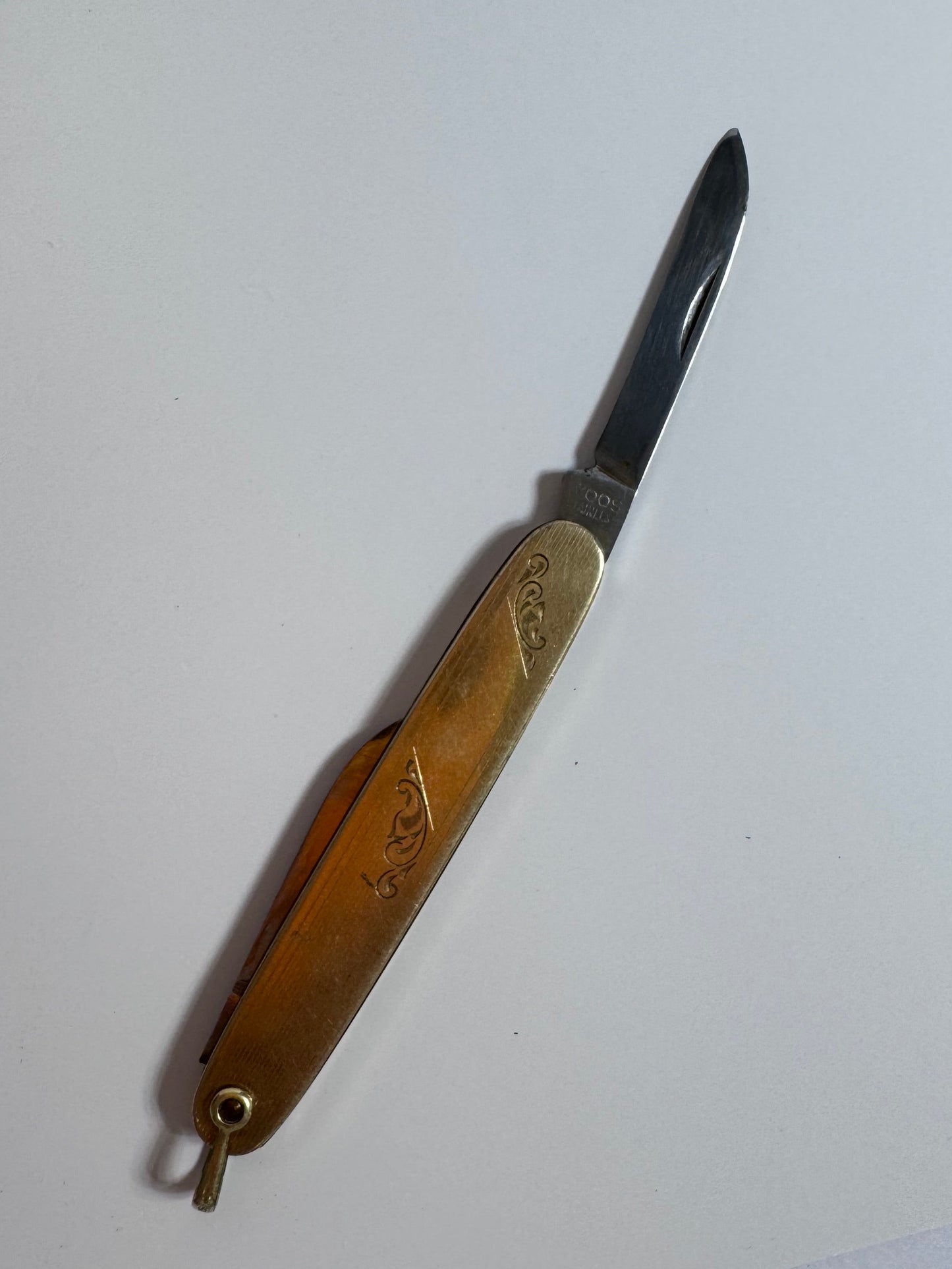 Vintage 10K gold pocket knife pendant with working steel blade, engine turned texture and engraved details, functional jewelry