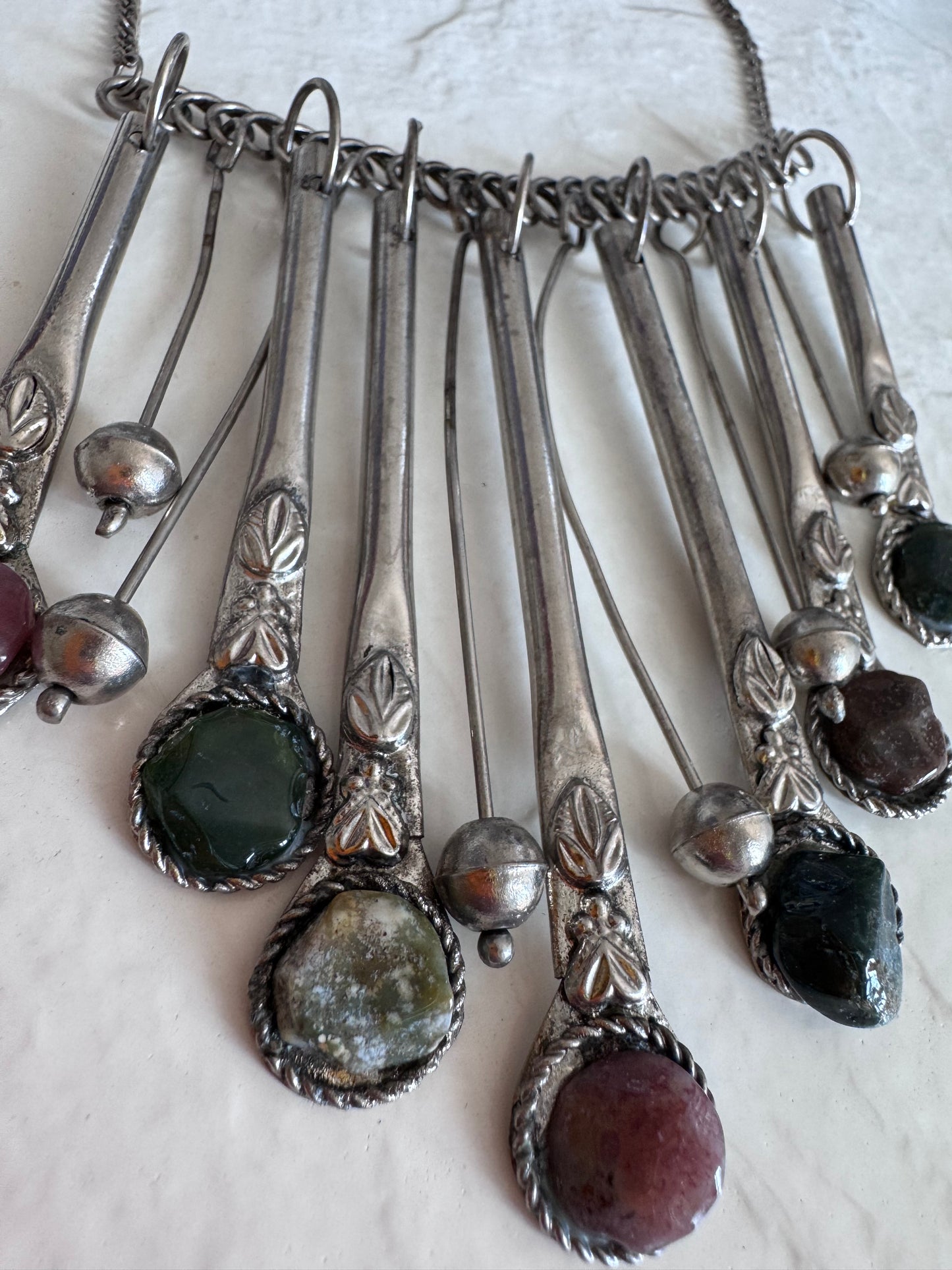 Estate vintage silver fringe necklace with multiple natural stones in purple green and brown tones showing bohemian statement jewelry design