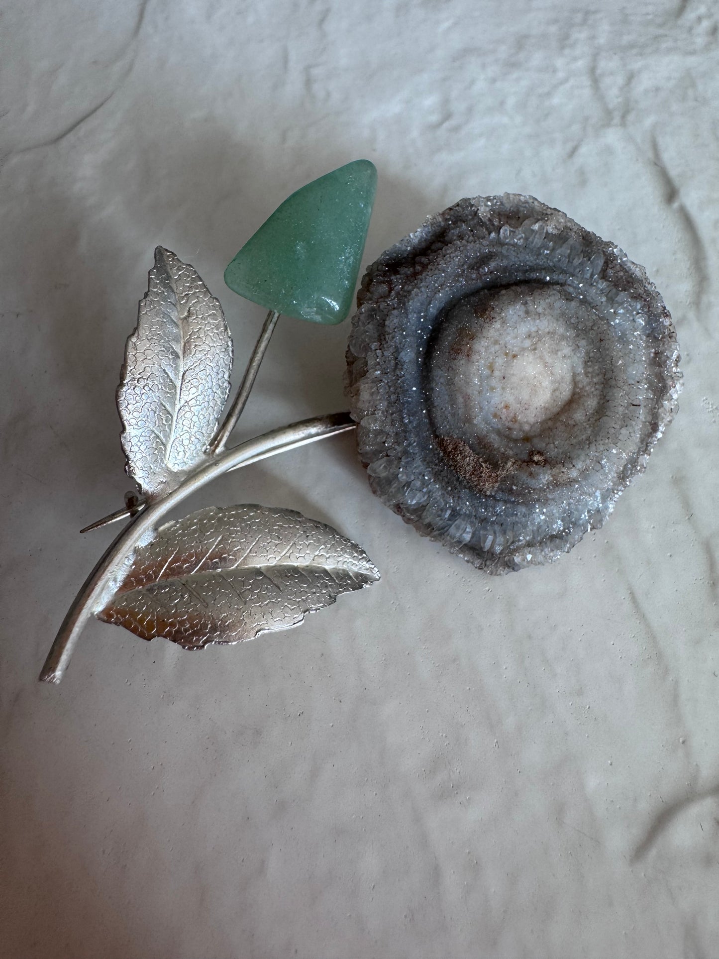 Estate Soviet silver flower brooch with natural druzy geode center and green aventurine bud, showing textured leaves and crystalline details