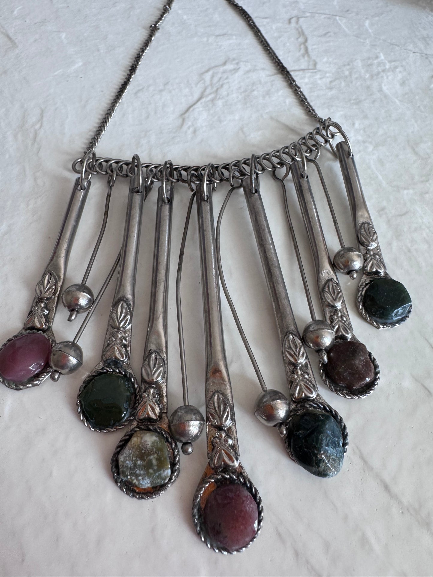 Estate vintage silver fringe necklace with multiple natural stones in purple green and brown tones showing bohemian statement jewelry design