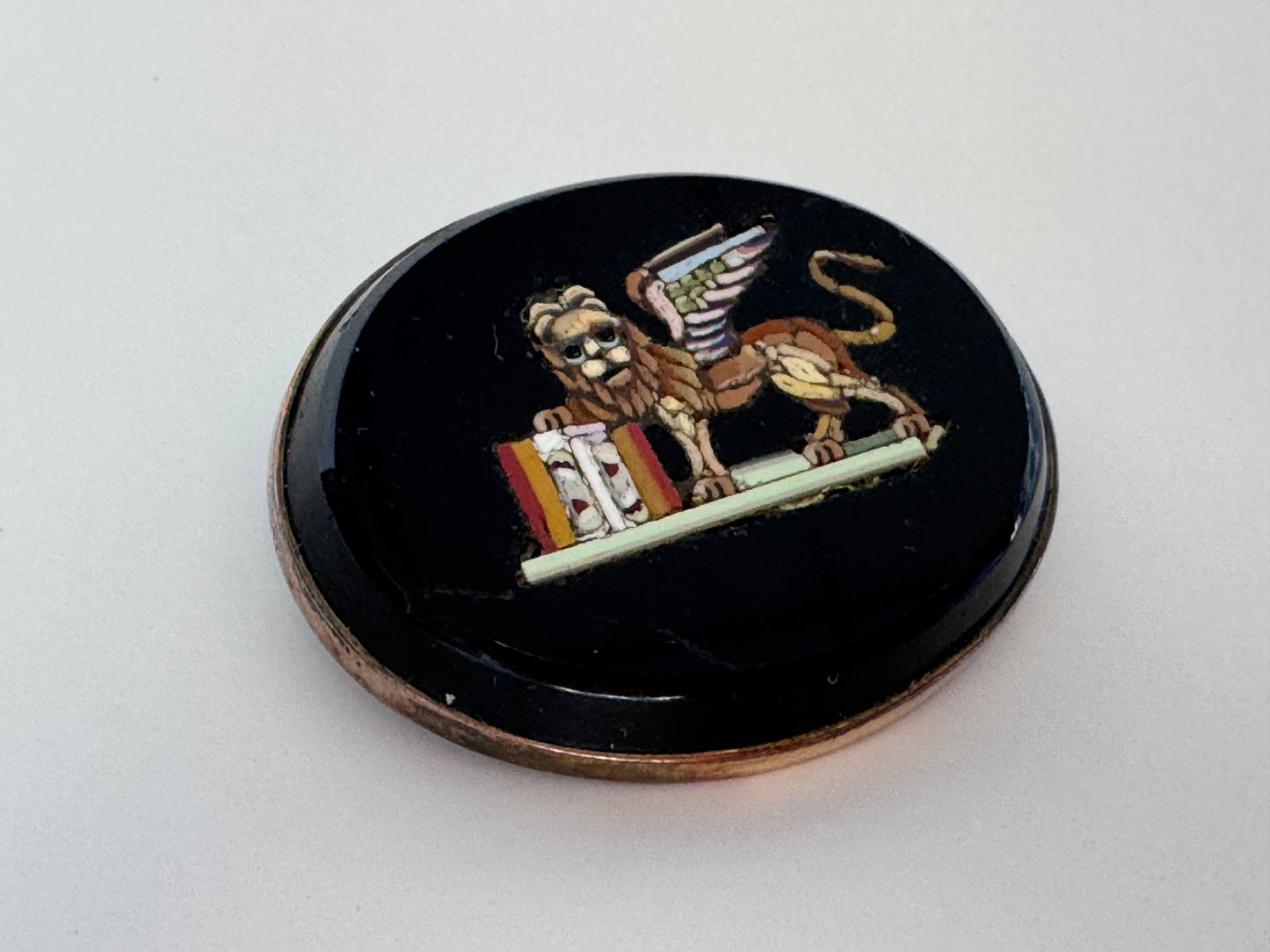 Antique sterling silver micro mosaic brooch featuring winged Lion of St. Mark in colorful glass tesserae on black background, Venetian Grand Tour souvenir jewelry
