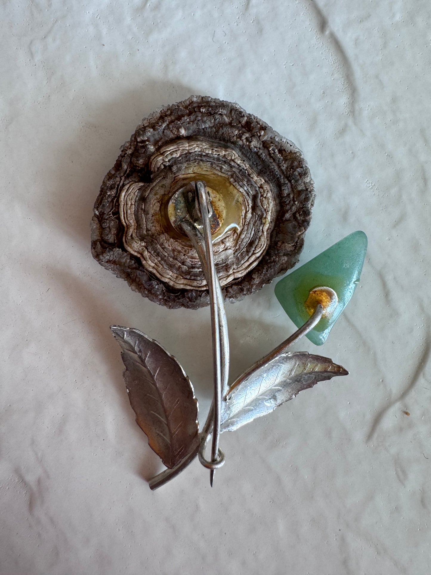Estate Soviet silver flower brooch with natural druzy geode center and green aventurine bud, showing textured leaves and crystalline details