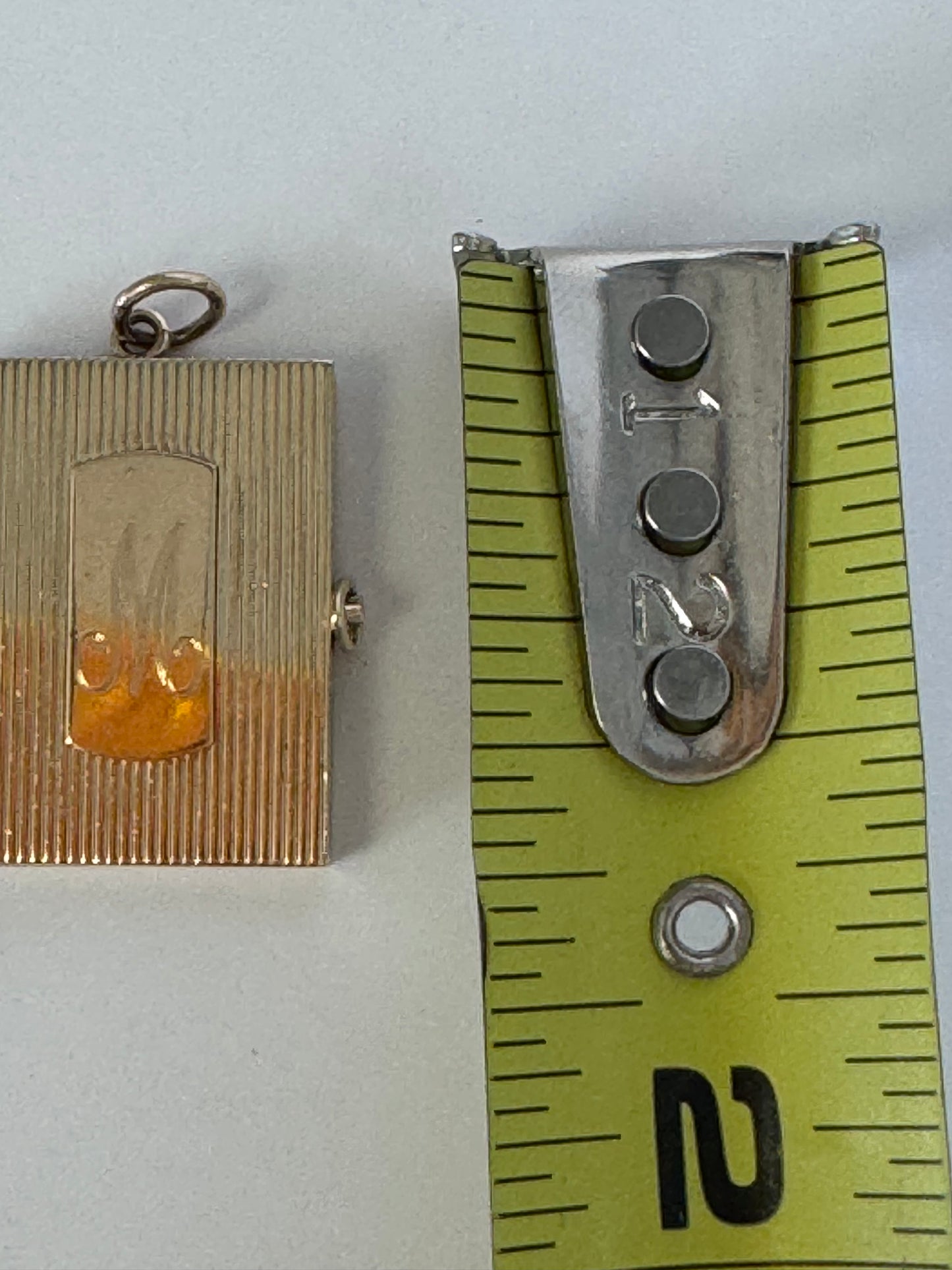 Vintage 14K gold book locket with hinged pages, engine-turned texture, engraved details, multiple photo compartments