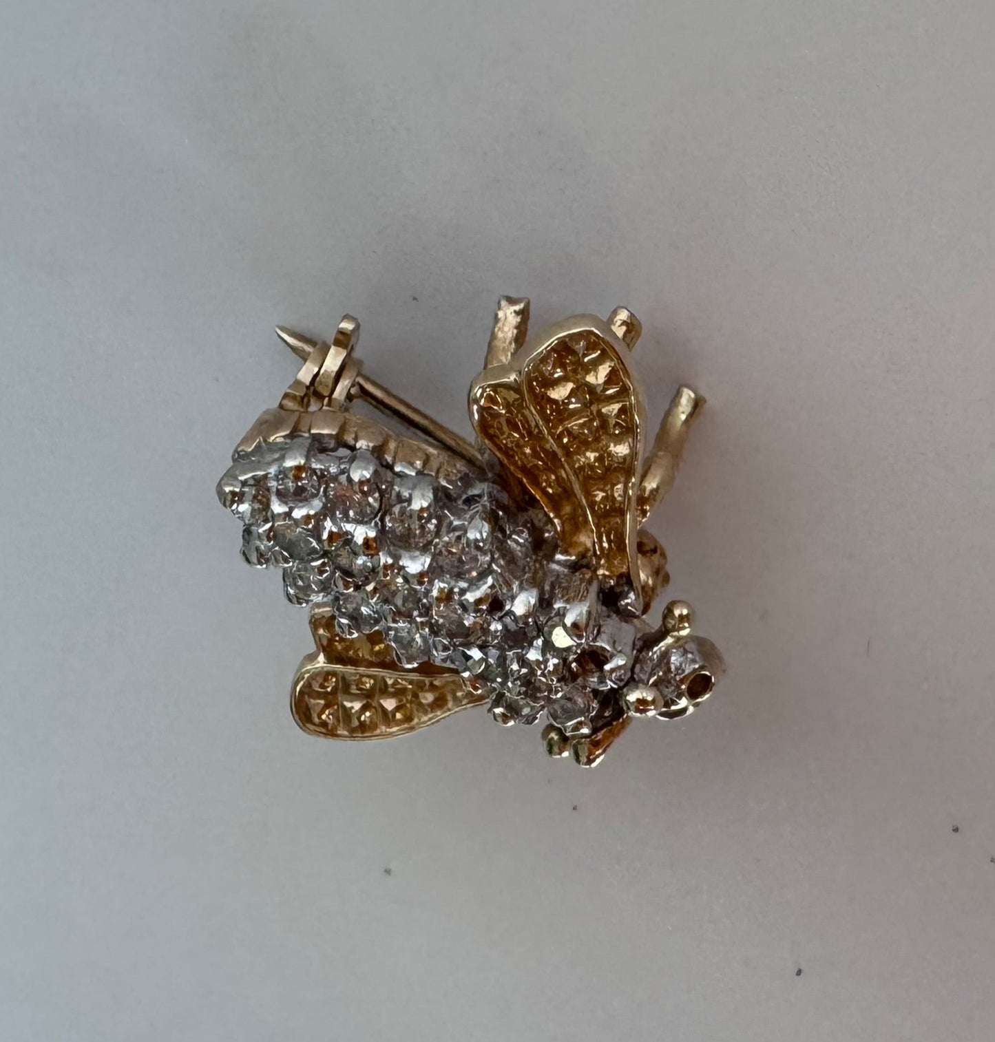 Estate 14K gold bee brooch with diamond-encrusted body and textured wings, vintage insect pin jewelry