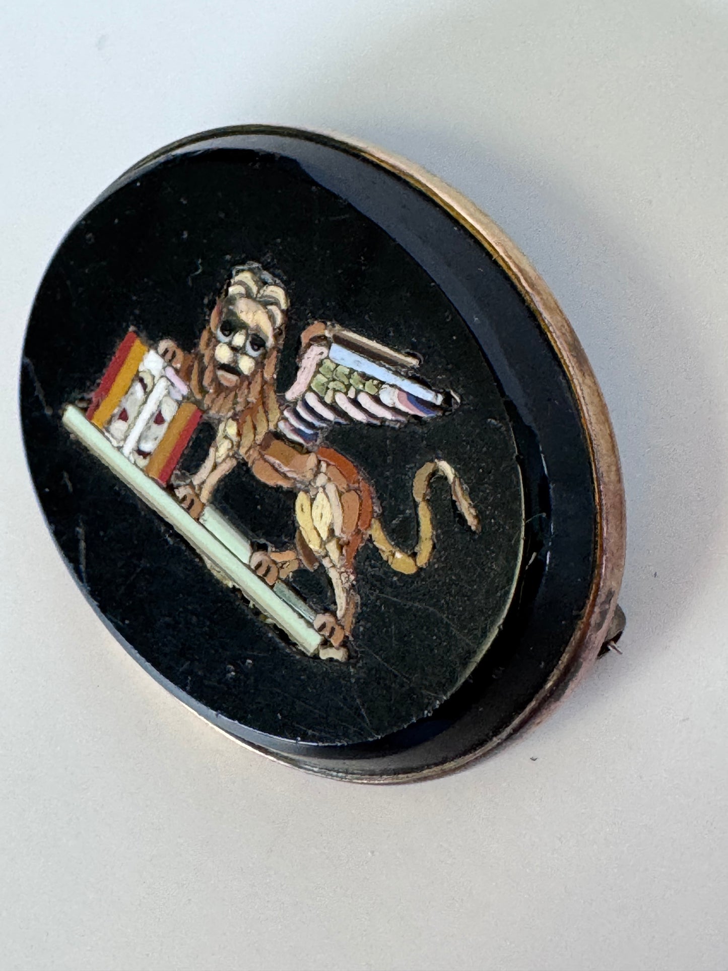 Antique sterling silver micro mosaic brooch featuring winged Lion of St. Mark in colorful glass tesserae on black background, Venetian Grand Tour souvenir jewelry