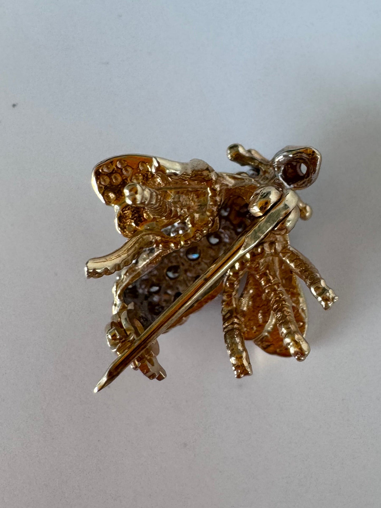 Estate 14K gold bee brooch with diamond-encrusted body and textured wings, vintage insect pin jewelry