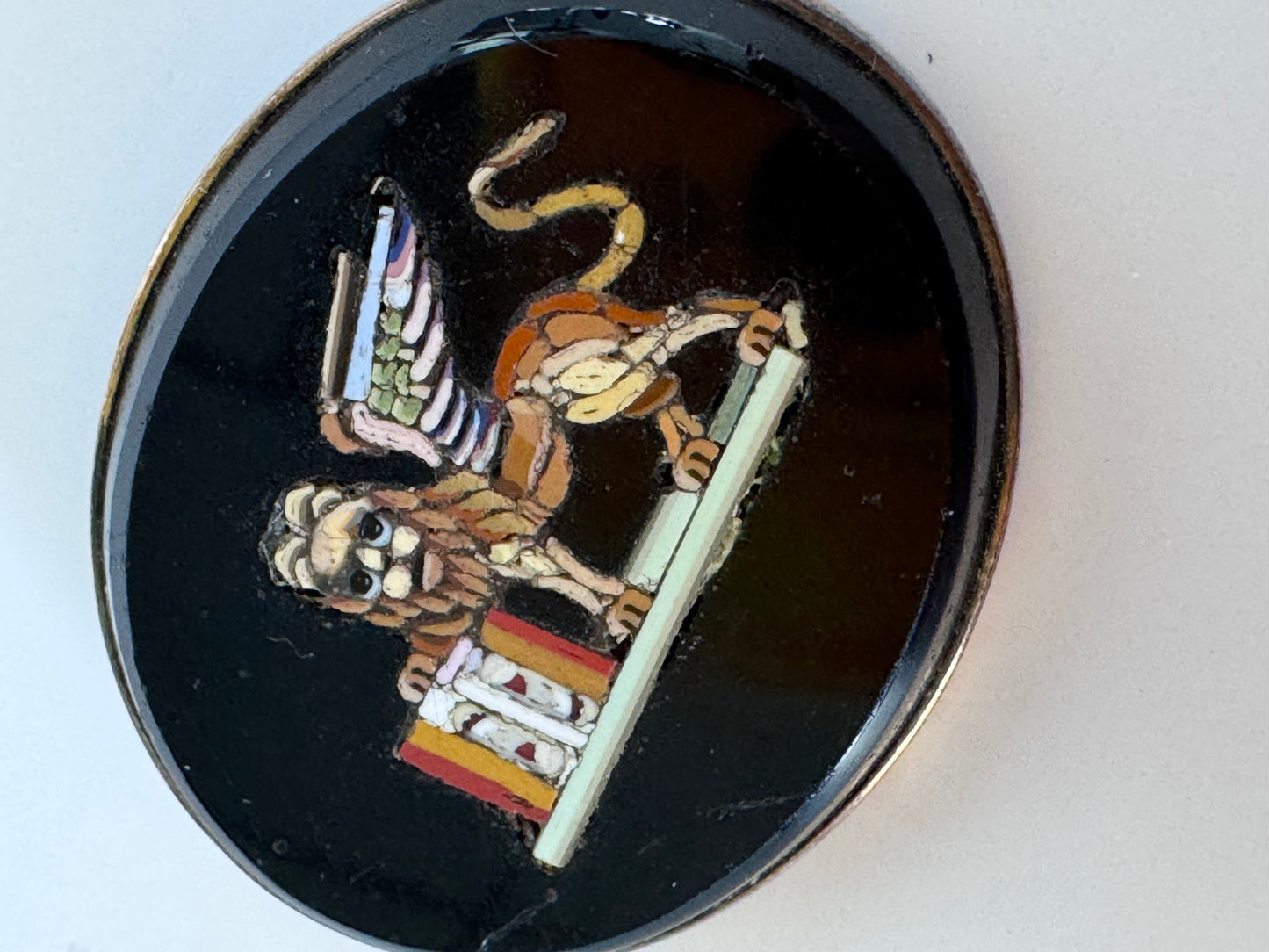Antique sterling silver micro mosaic brooch featuring winged Lion of St. Mark in colorful glass tesserae on black background, Venetian Grand Tour souvenir jewelry