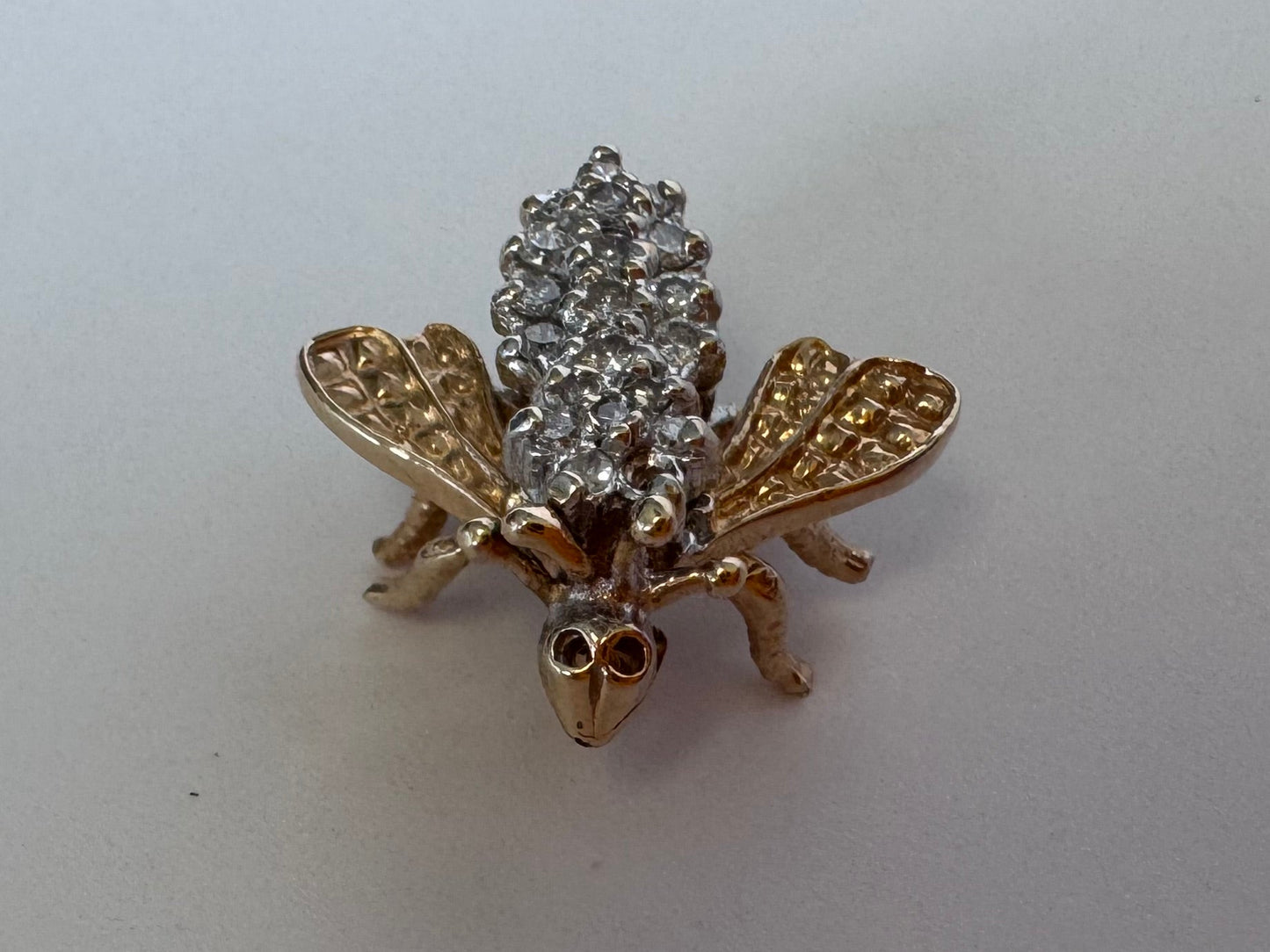 Estate 14K gold bee brooch with diamond-encrusted body and textured wings, vintage insect pin jewelry