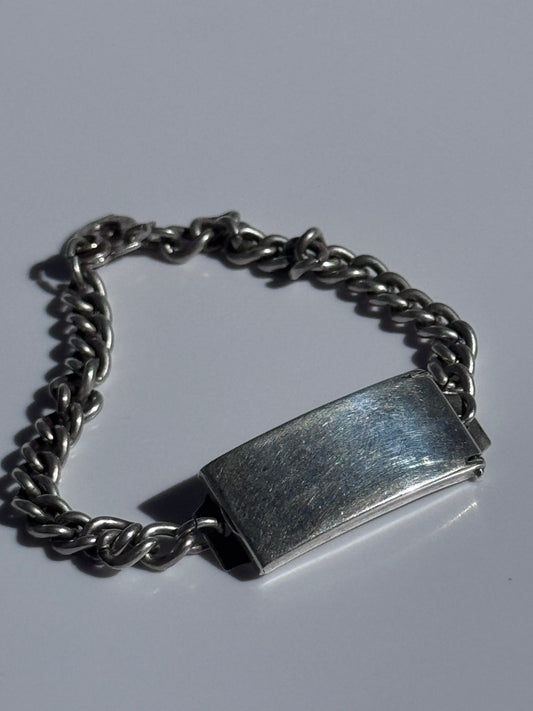 Vintage WWII sterling silver ID bracelet with curb chain and secret locket compartment, estate condition with engravable surface
