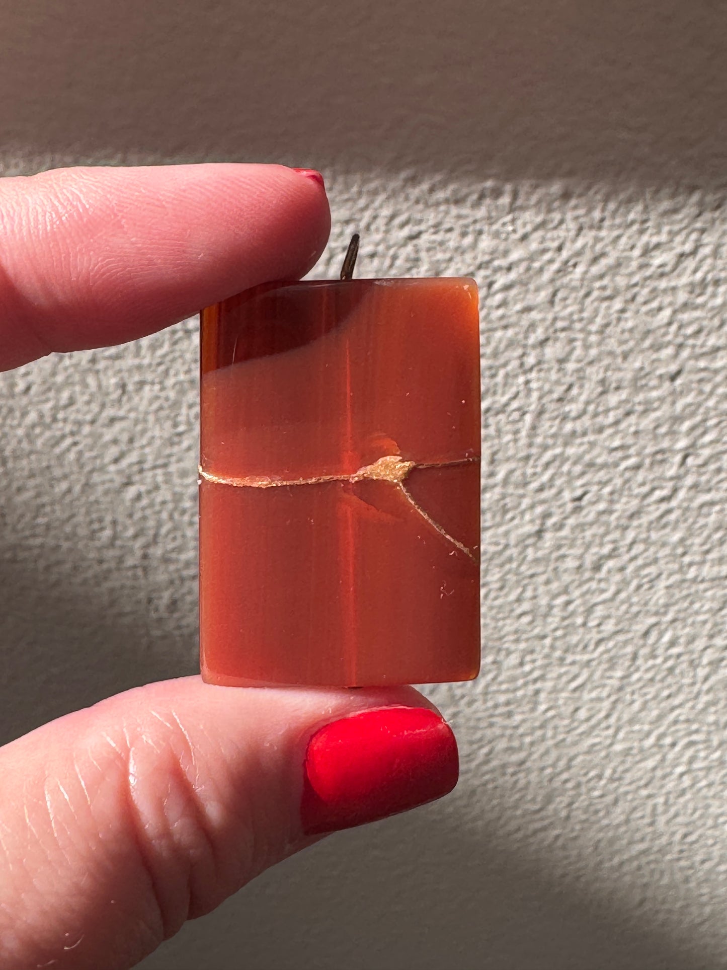 Estate 14K gold pendant featuring natural red carnelian rectangle with dramatic gold strike mineral inclusions embodying wabi sabi aesthetics