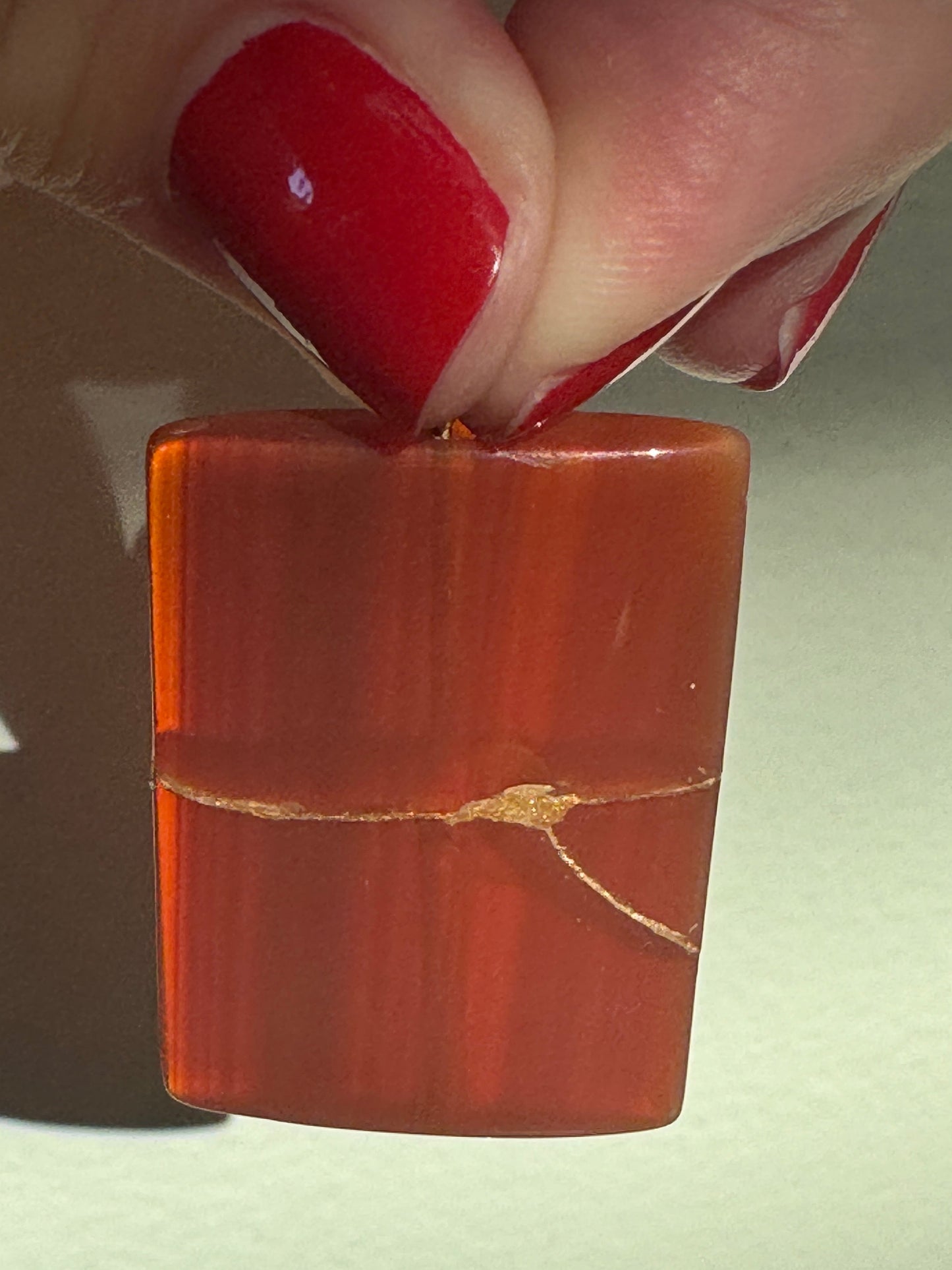 Estate 14K gold pendant featuring natural red carnelian rectangle with dramatic gold strike mineral inclusions embodying wabi sabi aesthetics