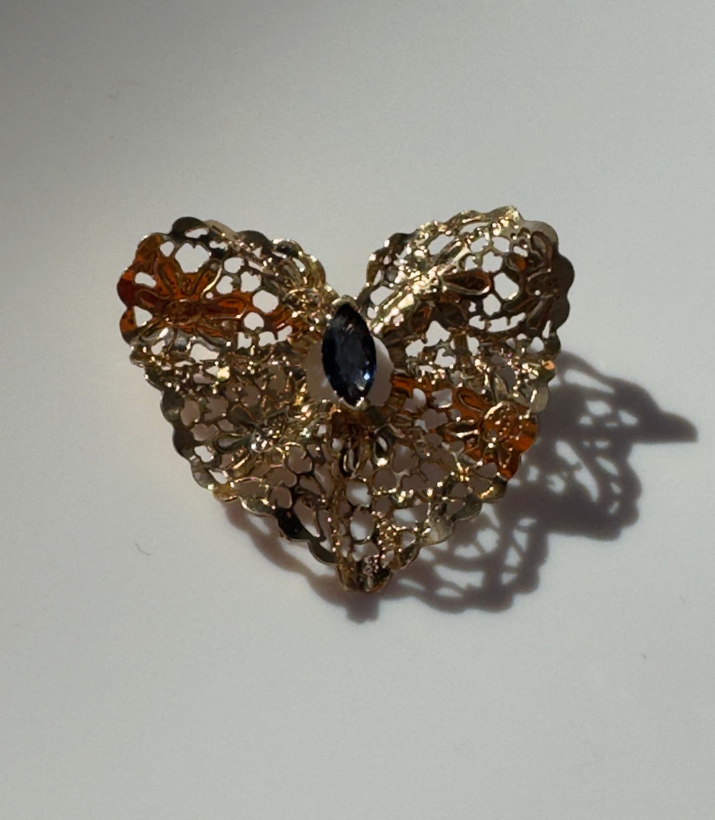 Estate 1980s 14K yellow gold heart slide pendant with blue sapphire centerstone and intricate pierced filigree openwork design