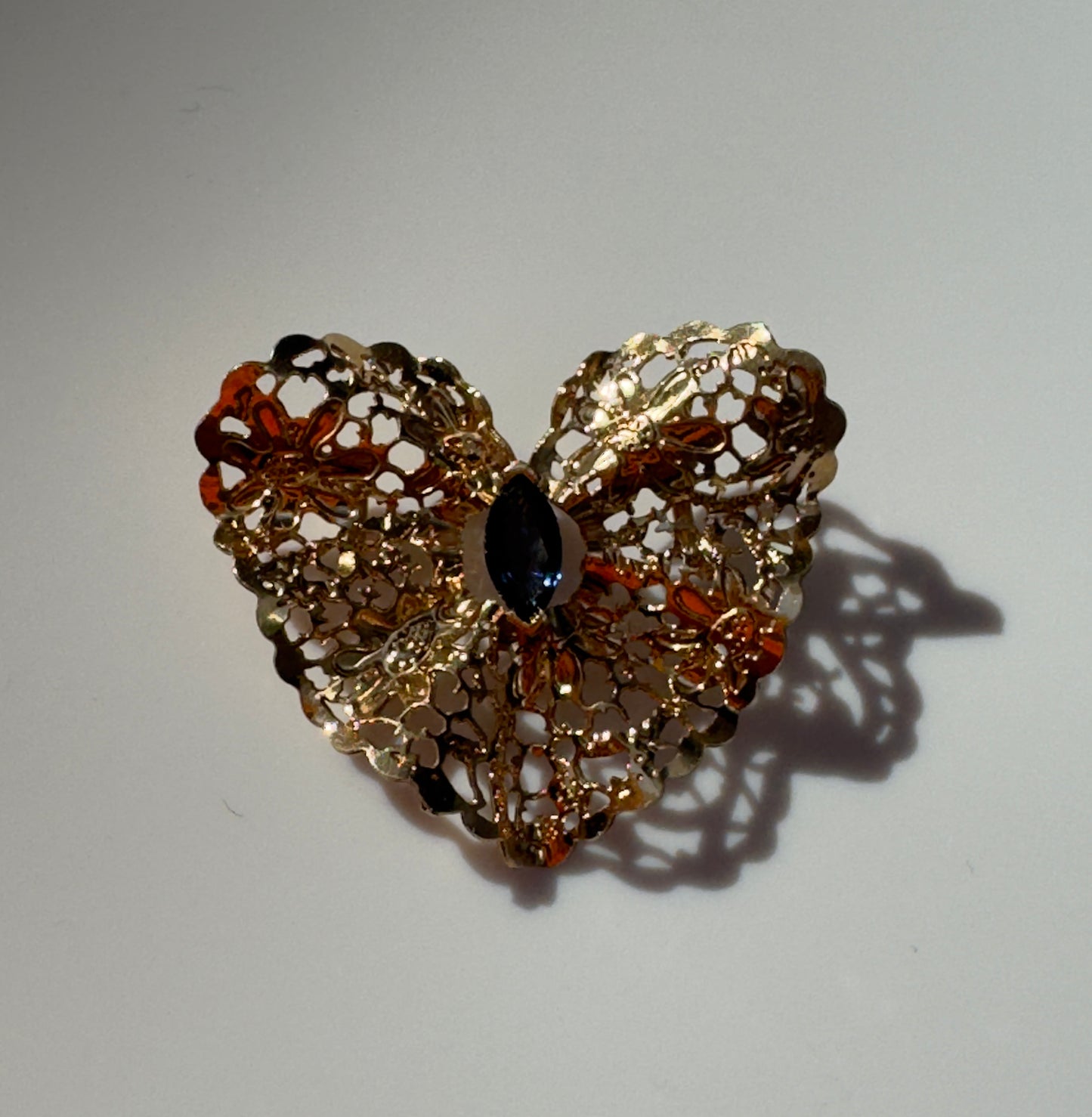 Estate 1980s 14K yellow gold heart slide pendant with blue sapphire centerstone and intricate pierced filigree openwork design