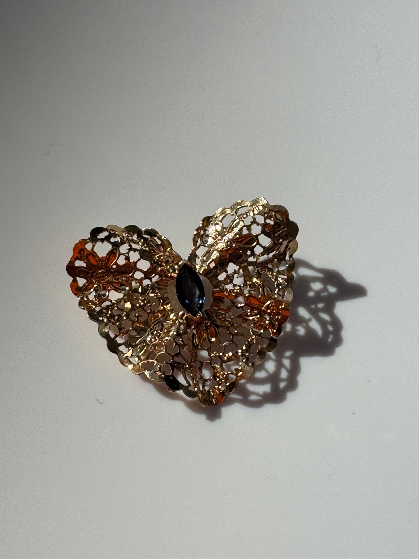 Estate 1980s 14K yellow gold heart slide pendant with blue sapphire centerstone and intricate pierced filigree openwork design