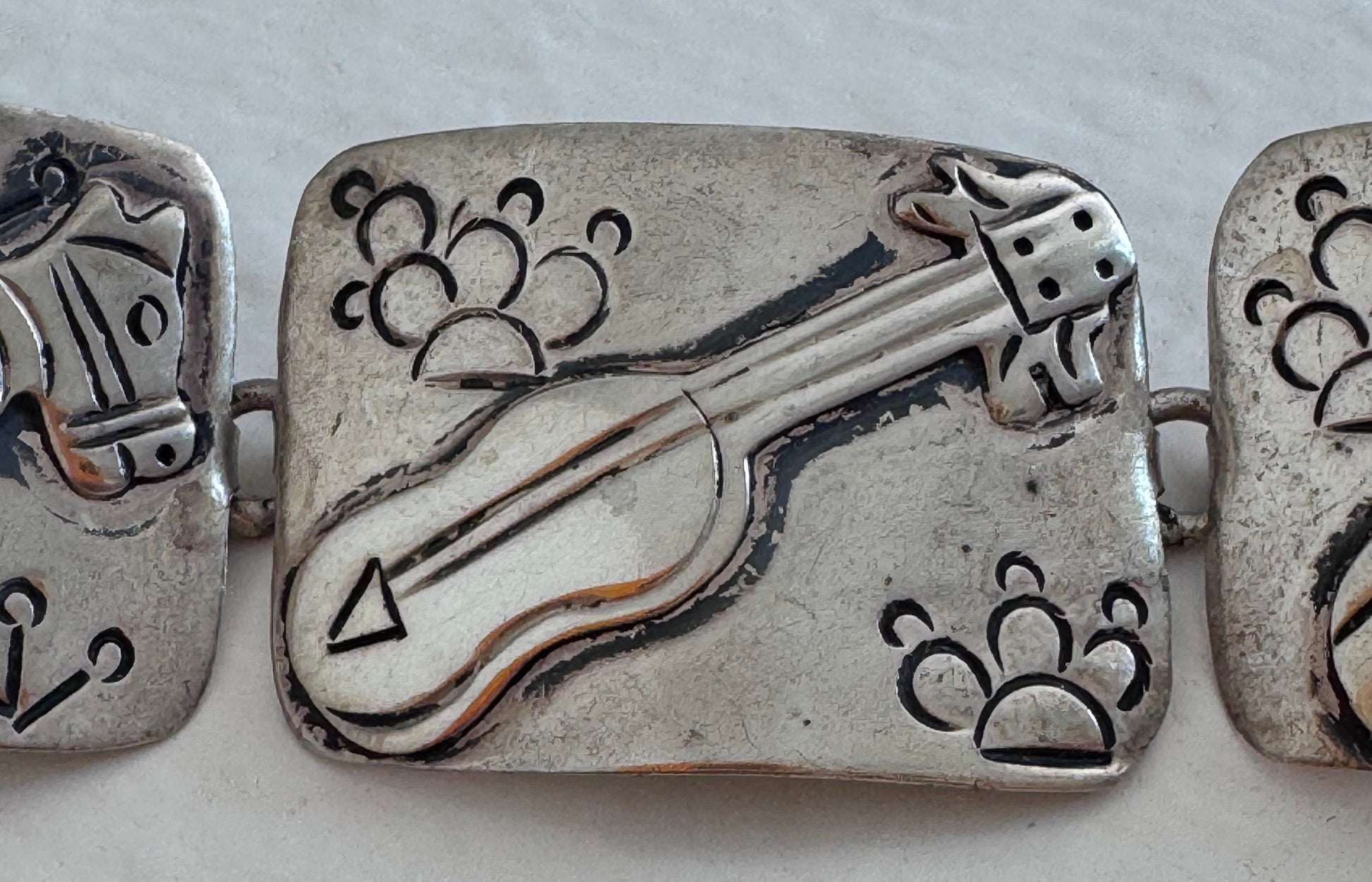 Estate J. Alvarez Taxco Mexican sterling silver storyteller panel bracelet showing detailed cultural scenes with guitar player, pottery, and folk motifs