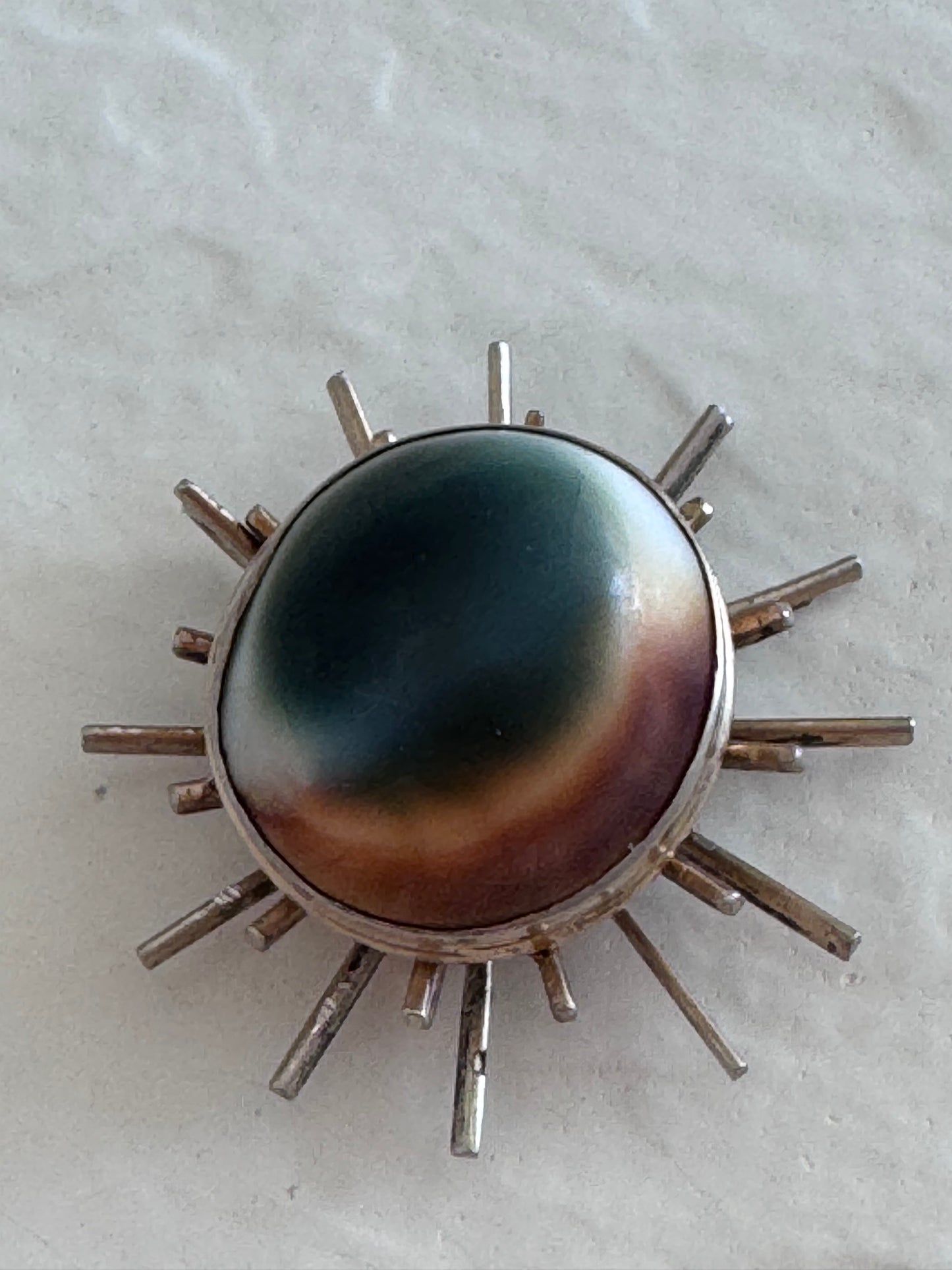 1940s sterling silver sunburst pendant with natural operculum center, WWII era modernist design with gold wash