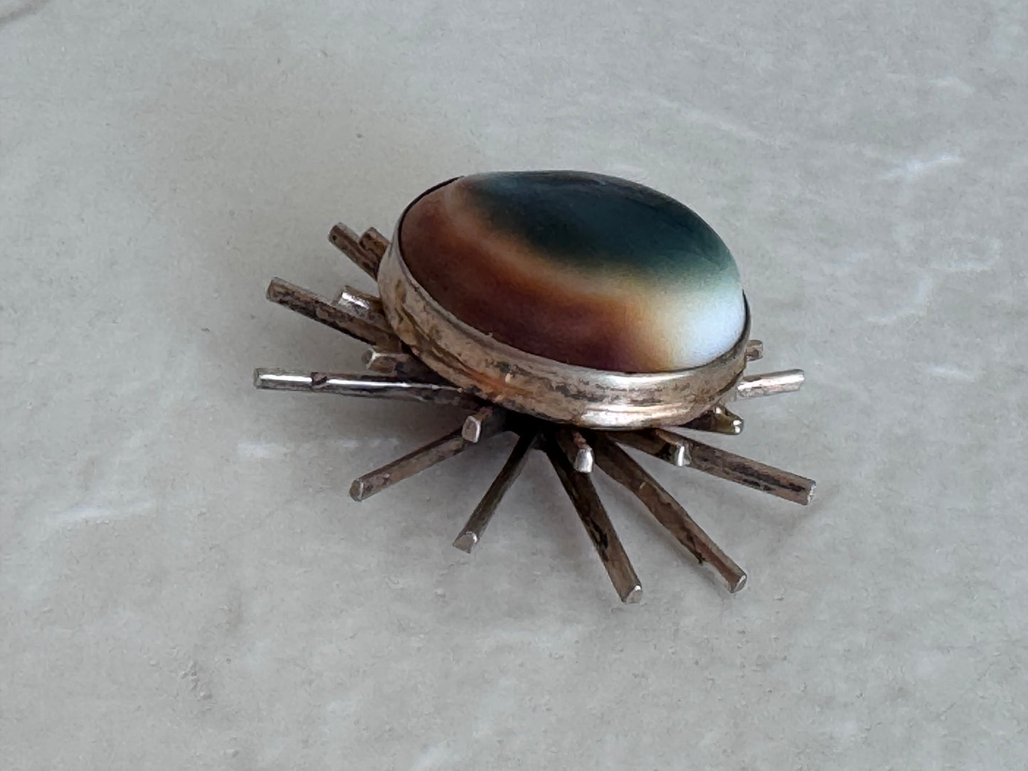 1940s sterling silver sunburst pendant with natural operculum center, WWII era modernist design with gold wash