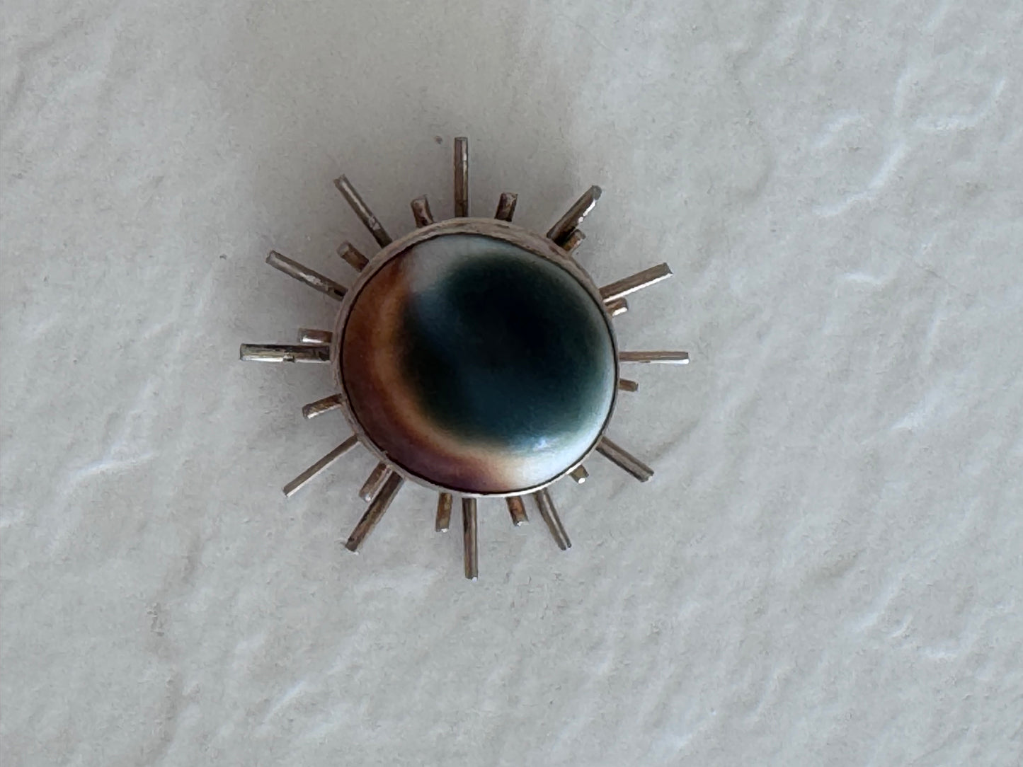 1940s sterling silver sunburst pendant with natural operculum center, WWII era modernist design with gold wash