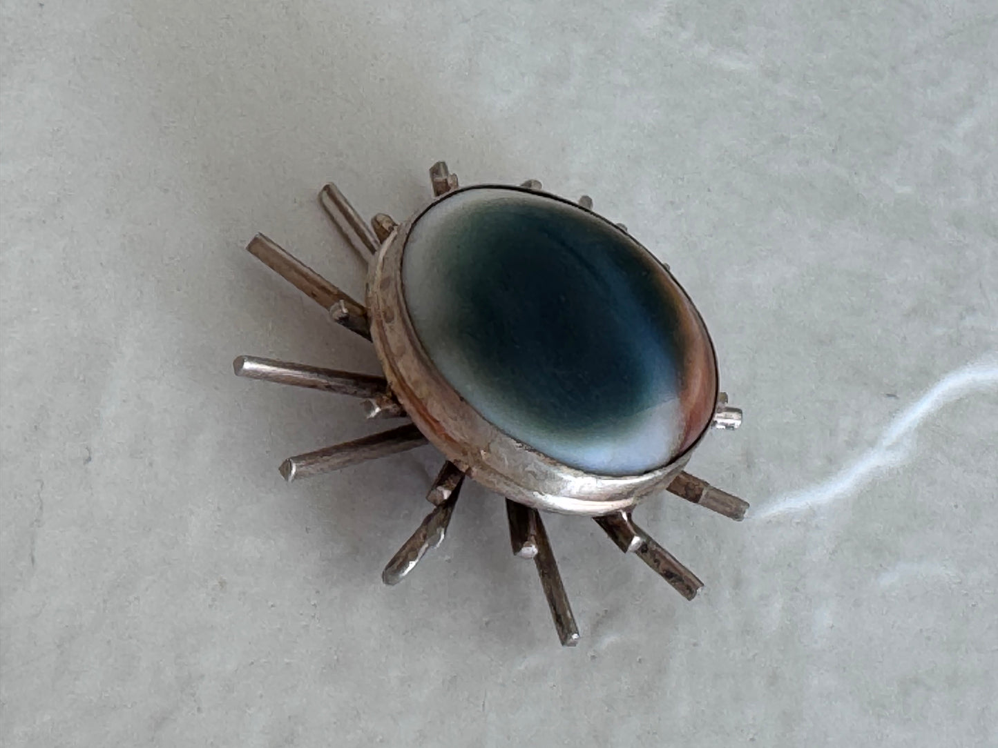 1940s sterling silver sunburst pendant with natural operculum center, WWII era modernist design with gold wash