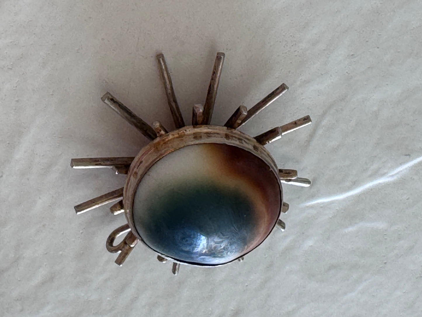 1940s sterling silver sunburst pendant with natural operculum center, WWII era modernist design with gold wash