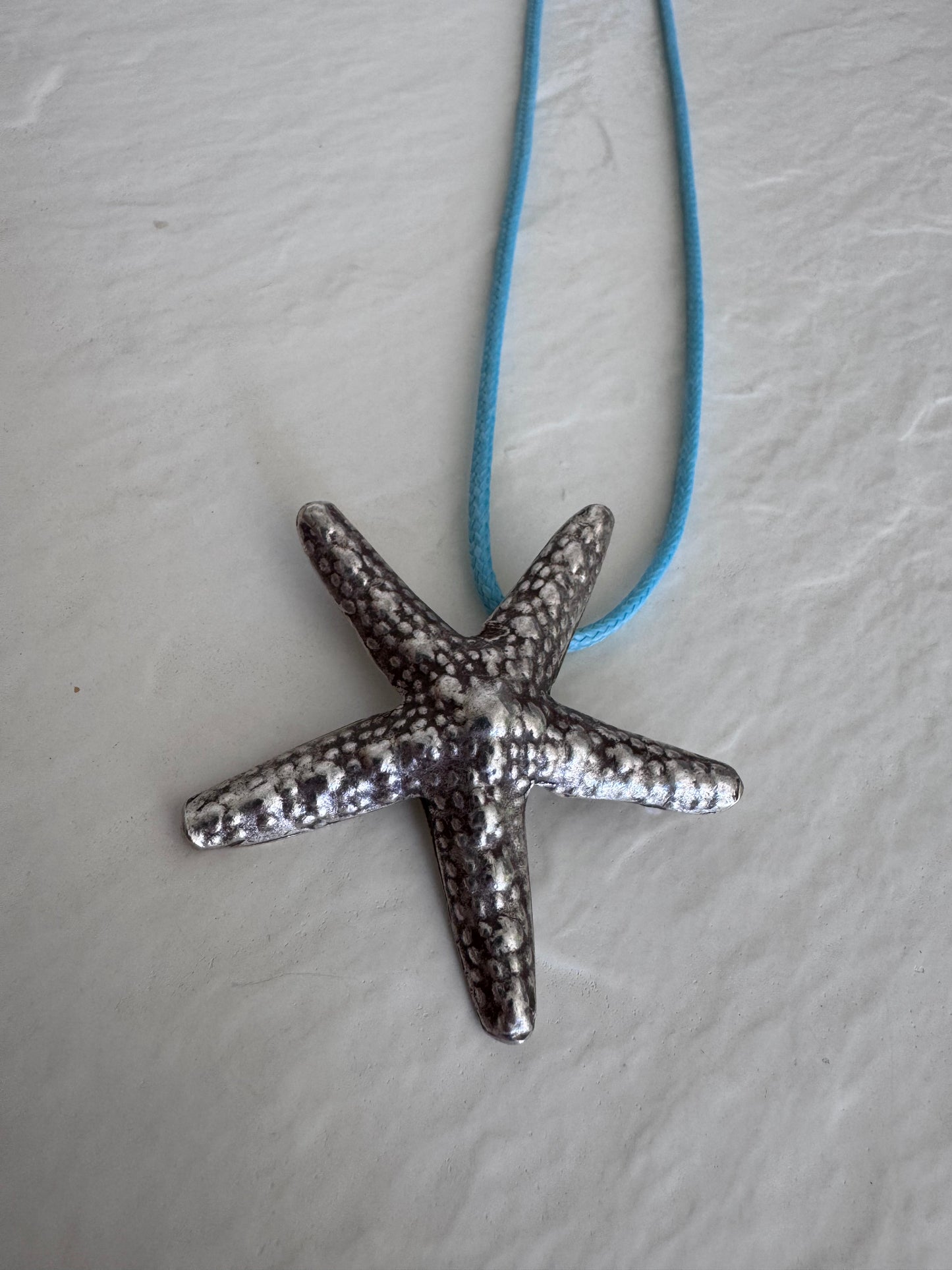Large Karen Hill Tribe silver starfish pendants with textured surface showing authentic handcrafted details and hidden bail construction