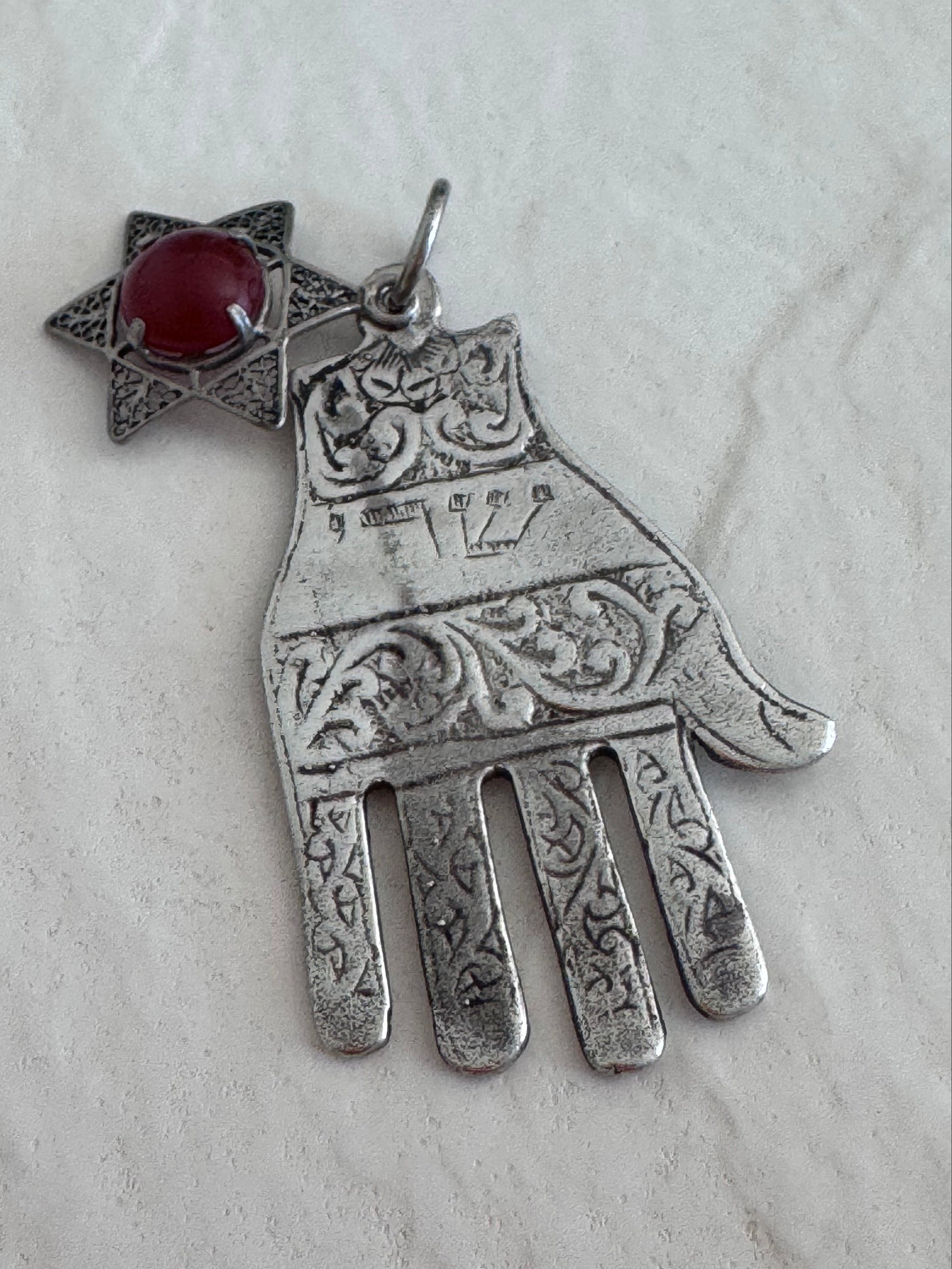 Sterling silver Hamsa hand pendant with Star of David and carnelian stone featuring detailed filigree work and Hebrew text