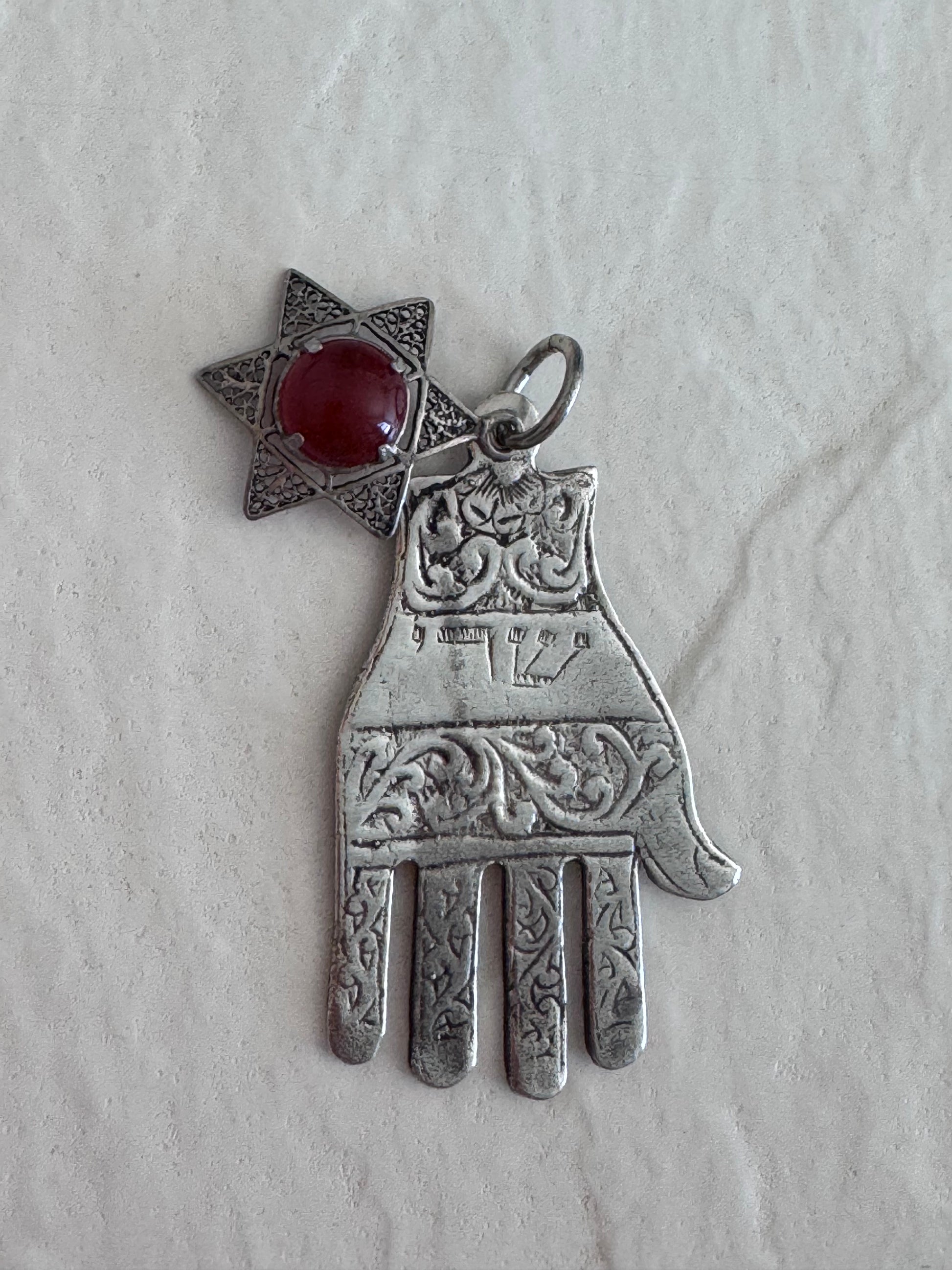 Sterling silver Hamsa hand pendant with Star of David and carnelian stone featuring detailed filigree work and Hebrew text