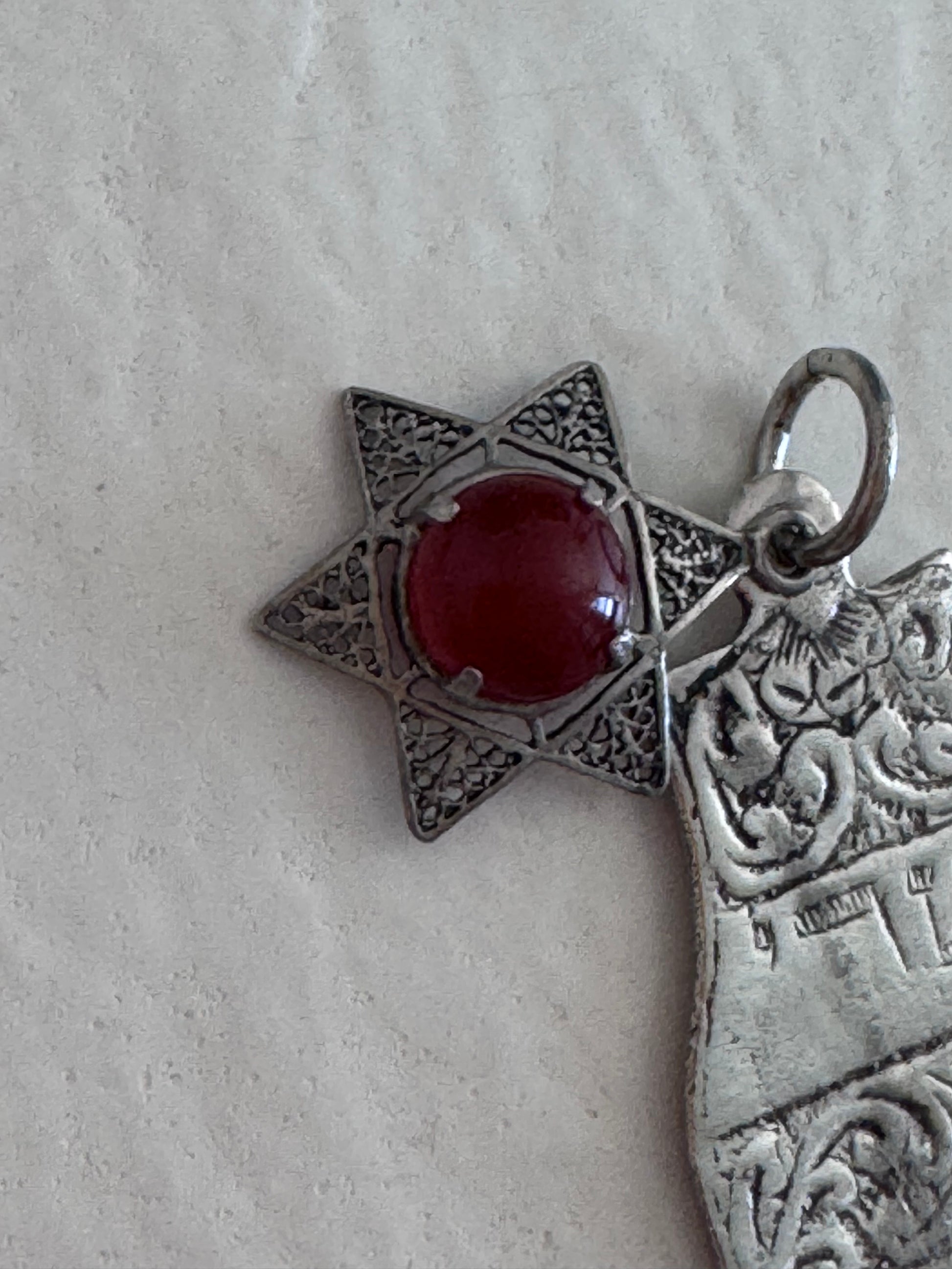 Sterling silver Hamsa hand pendant with Star of David and carnelian stone featuring detailed filigree work and Hebrew text