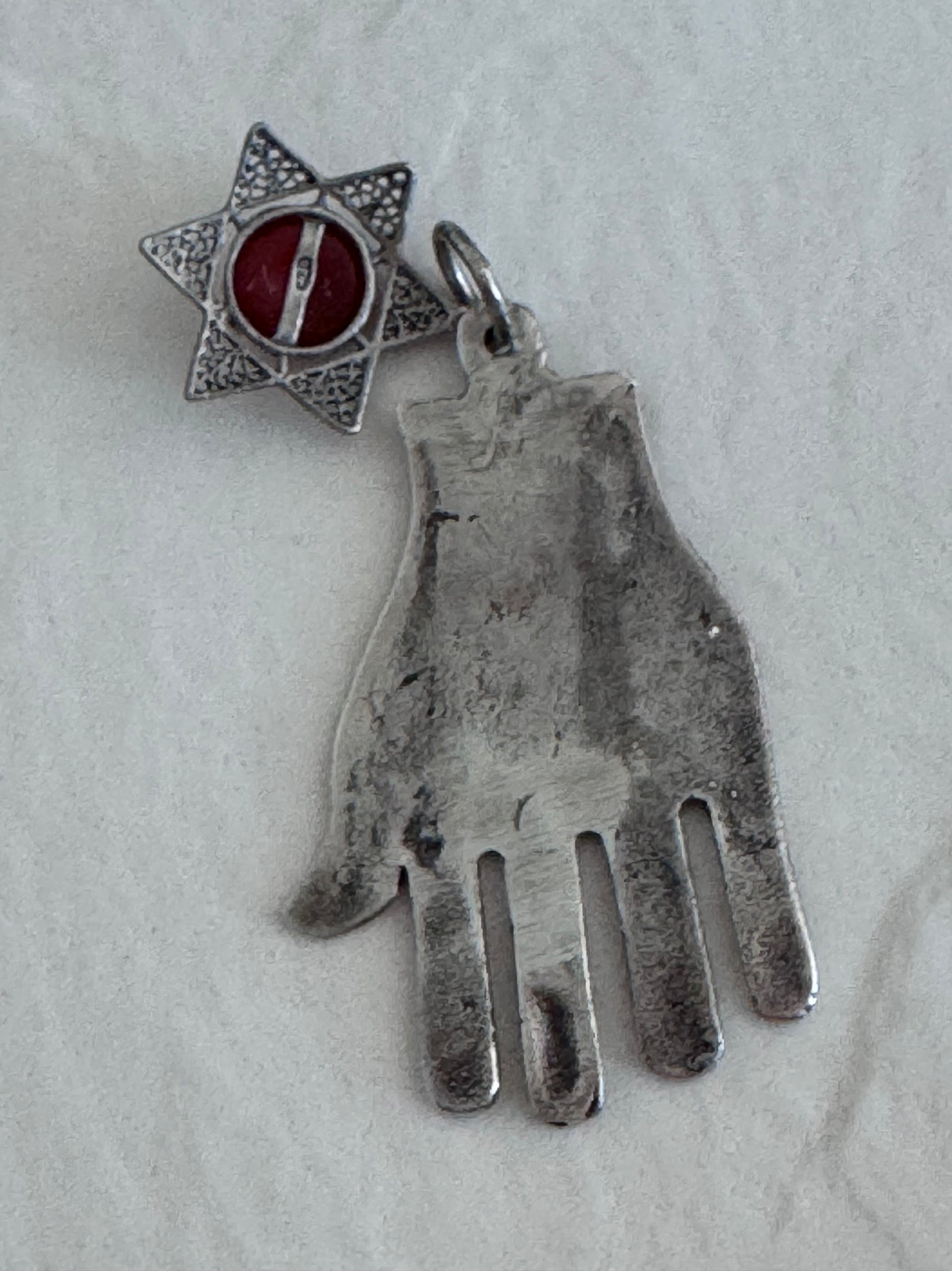 Sterling silver Hamsa hand pendant with Star of David and carnelian stone featuring detailed filigree work and Hebrew text