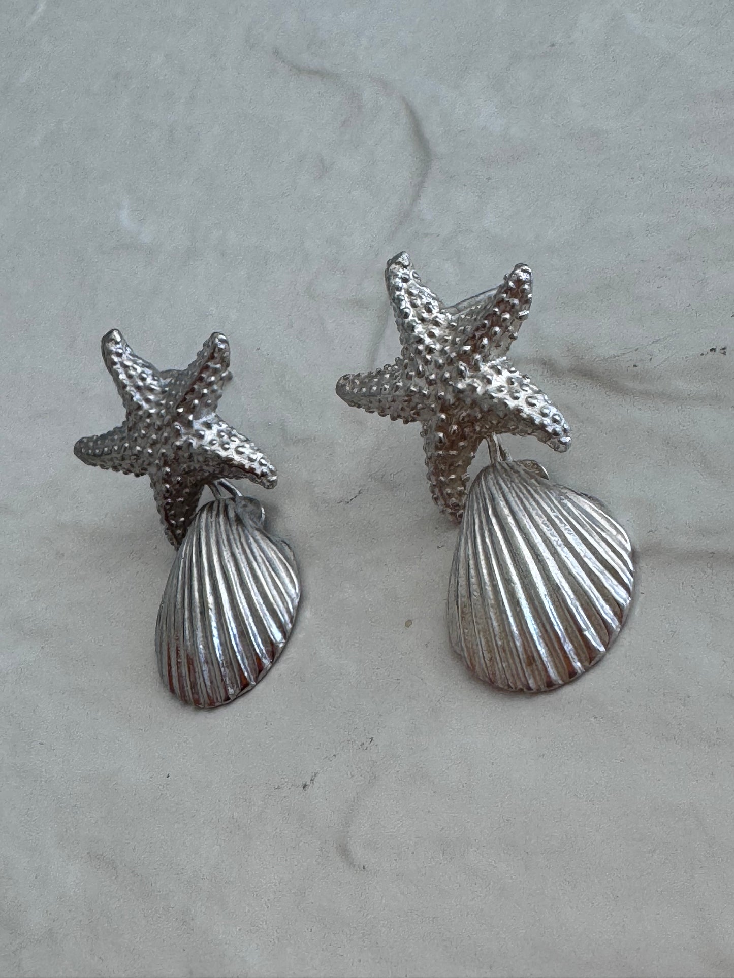 Vintage sterling silver starfish and shell drop earrings with textured detailing and wire connectionsVintage sterling silver starfish and shell drop earrings with textured detailing and wire connections