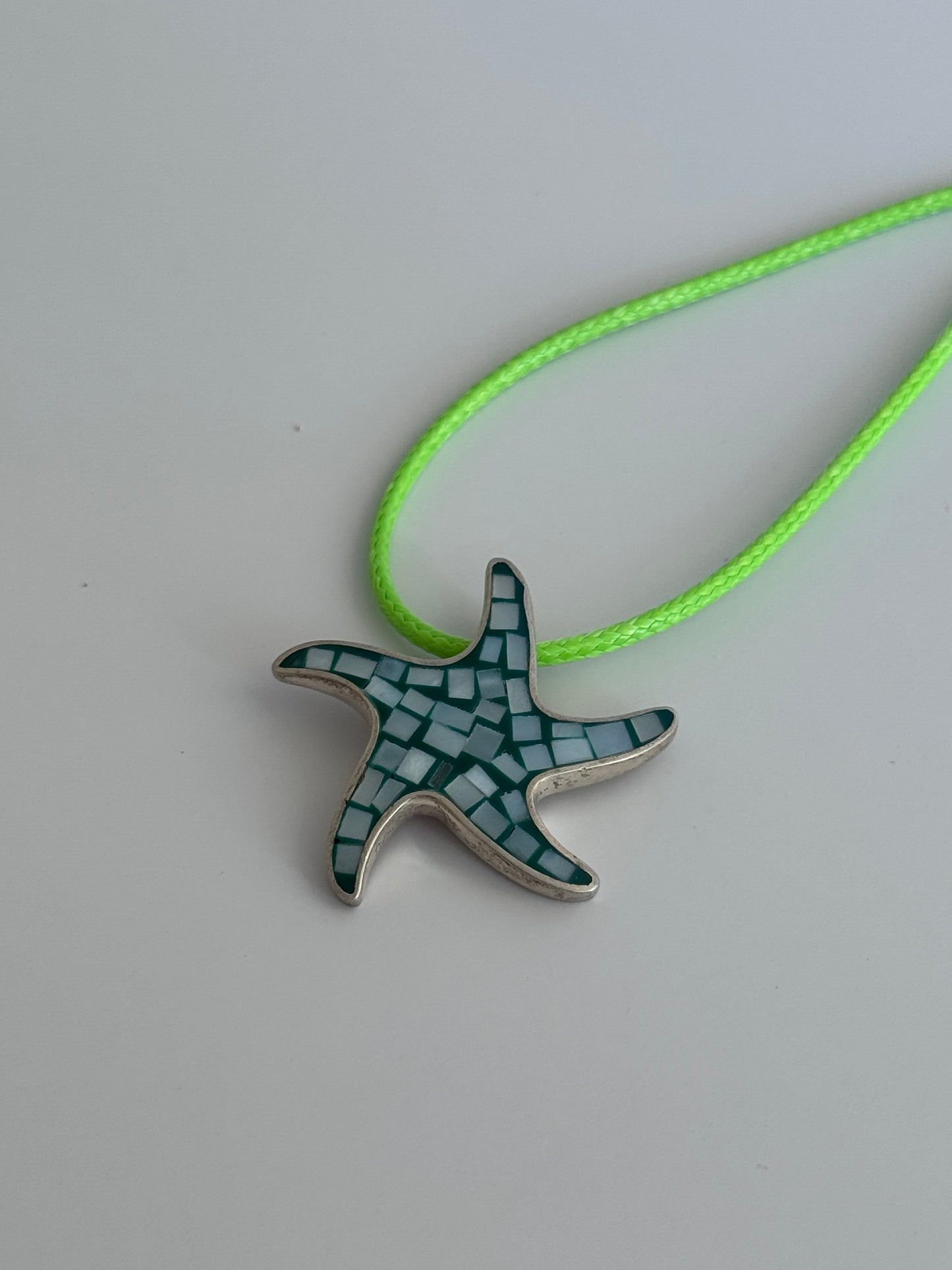 Vintage sterling silver starfish pendant with mother of pearl and green resin mosaic inlay, showing detailed craftsmanship and 925 hallmark