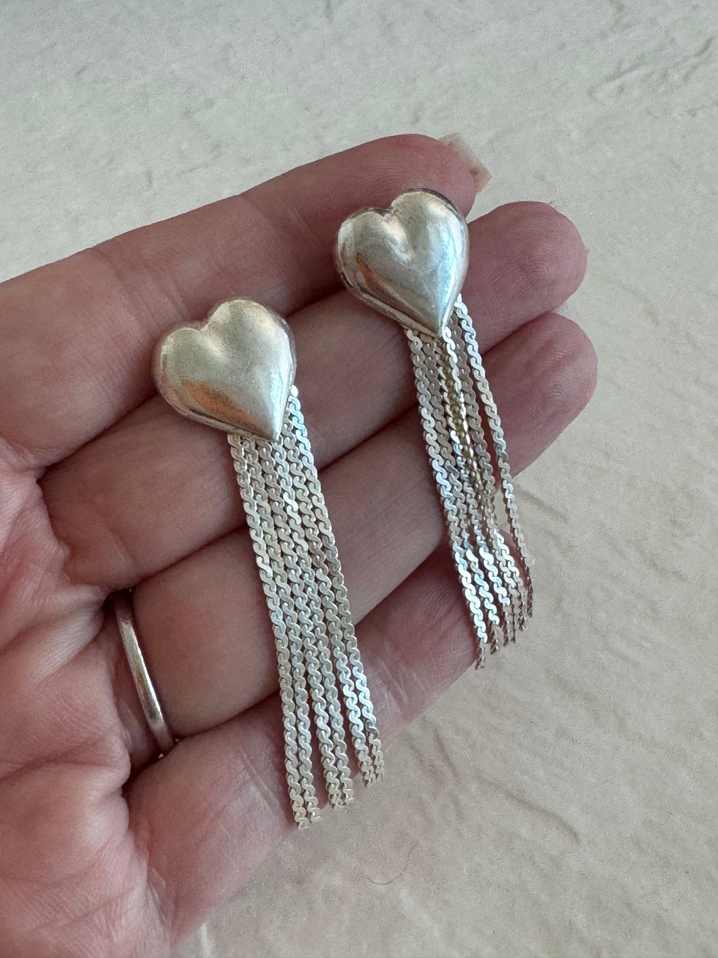 Vintage sterling silver puffy heart earrings with chain tassel fringe, showing 925 hallmarks and never-worn condition