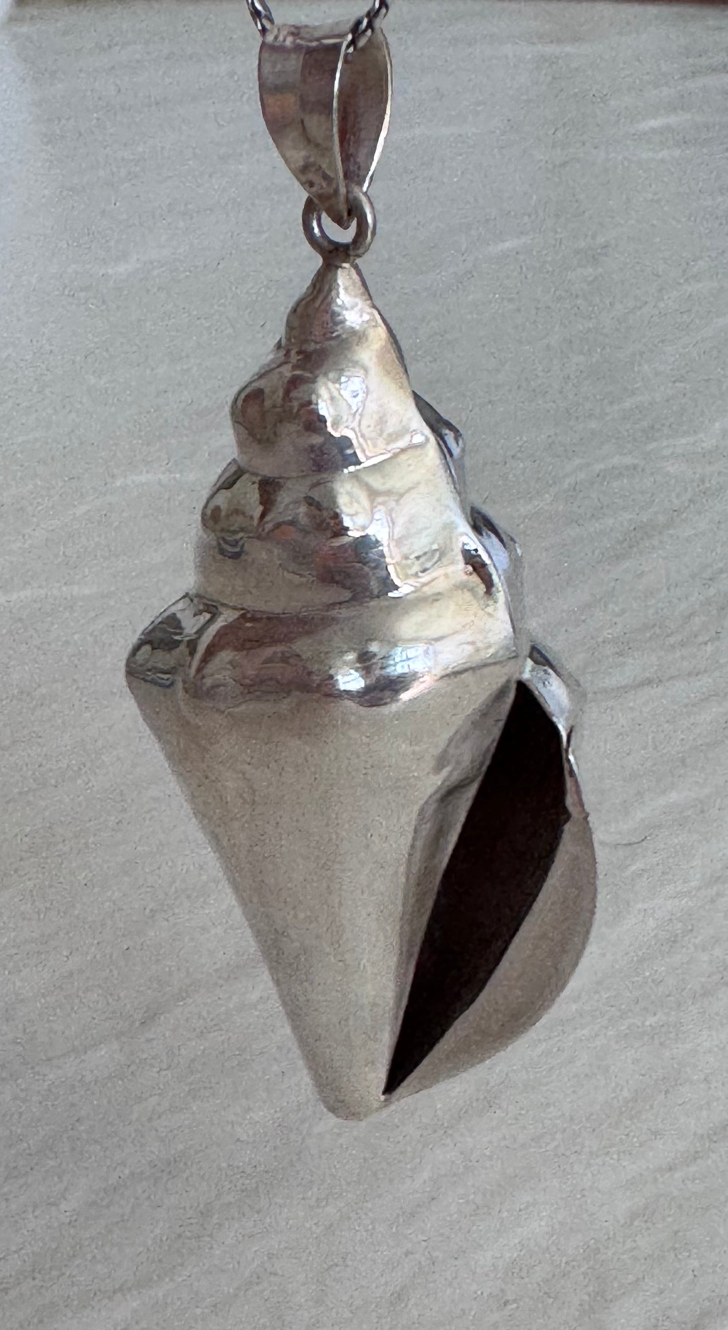 Large estate sterling silver conch shell pendant 2.75 inches long with hammered texture and included 14 inch chain, showing detailed spiral chambers
