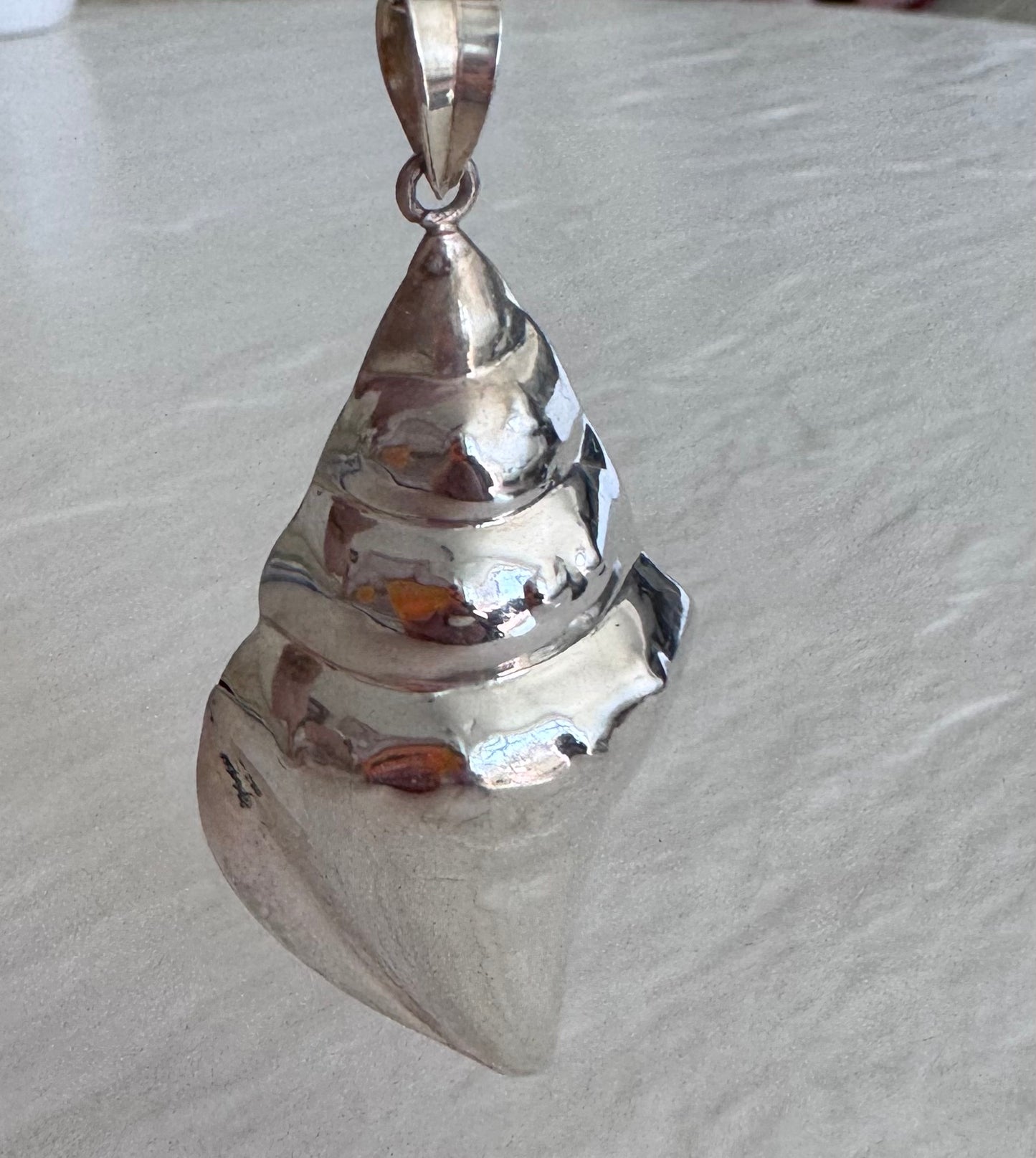 Large estate sterling silver conch shell pendant 2.75 inches long with hammered texture and included 14 inch chain, showing detailed spiral chambers