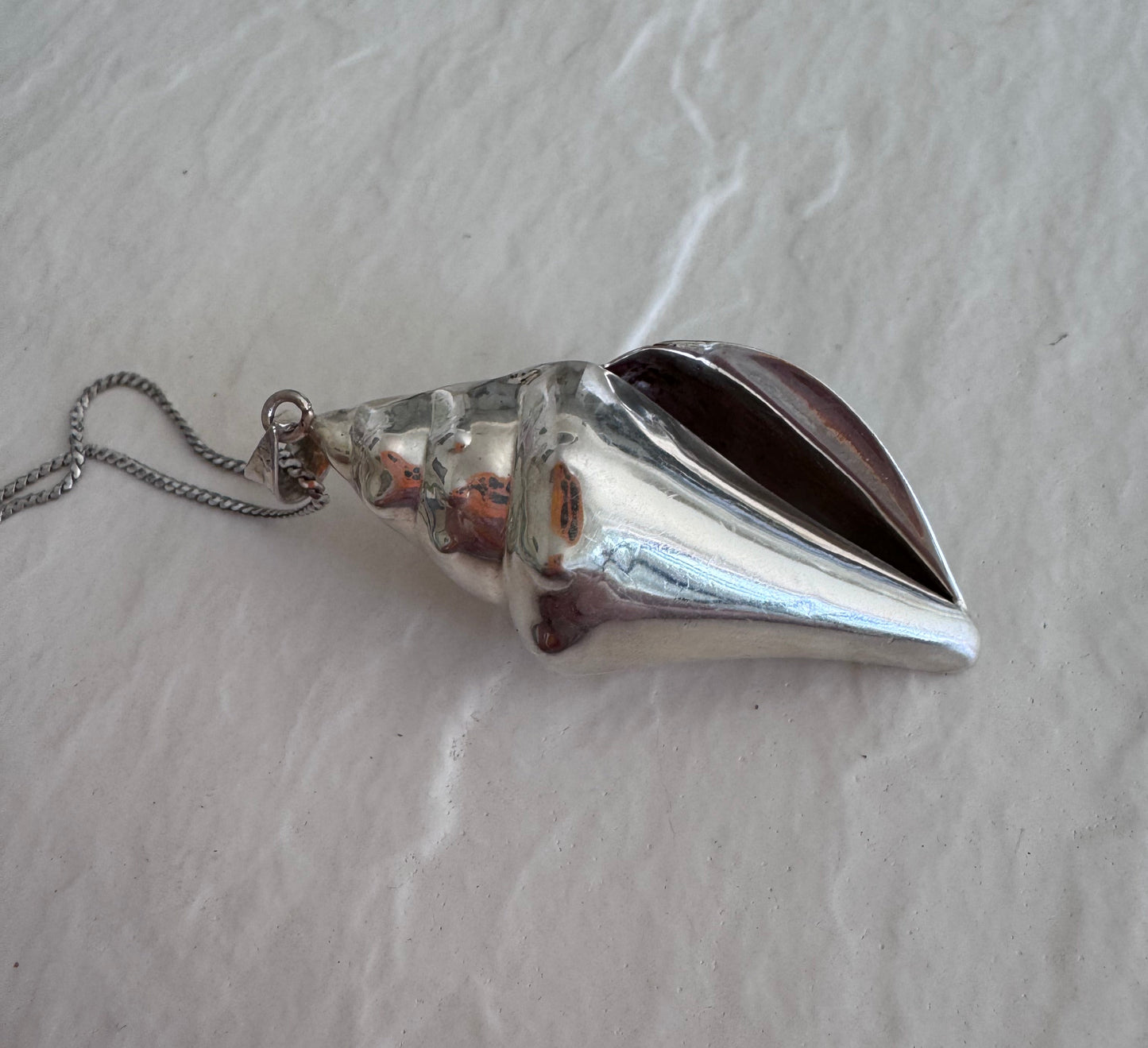 Large estate sterling silver conch shell pendant 2.75 inches long with hammered texture and included 14 inch chain, showing detailed spiral chambers