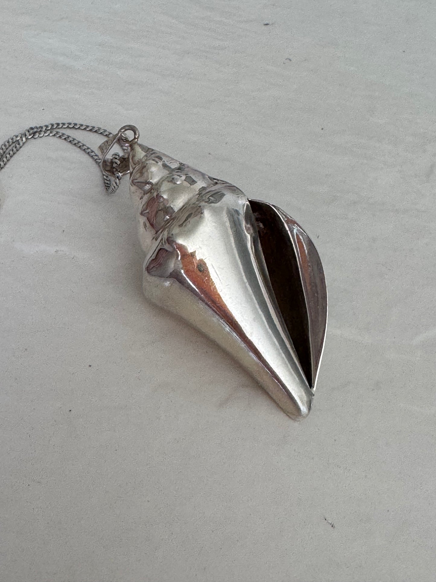 Large estate sterling silver conch shell pendant 2.75 inches long with hammered texture and included 14 inch chain, showing detailed spiral chambers