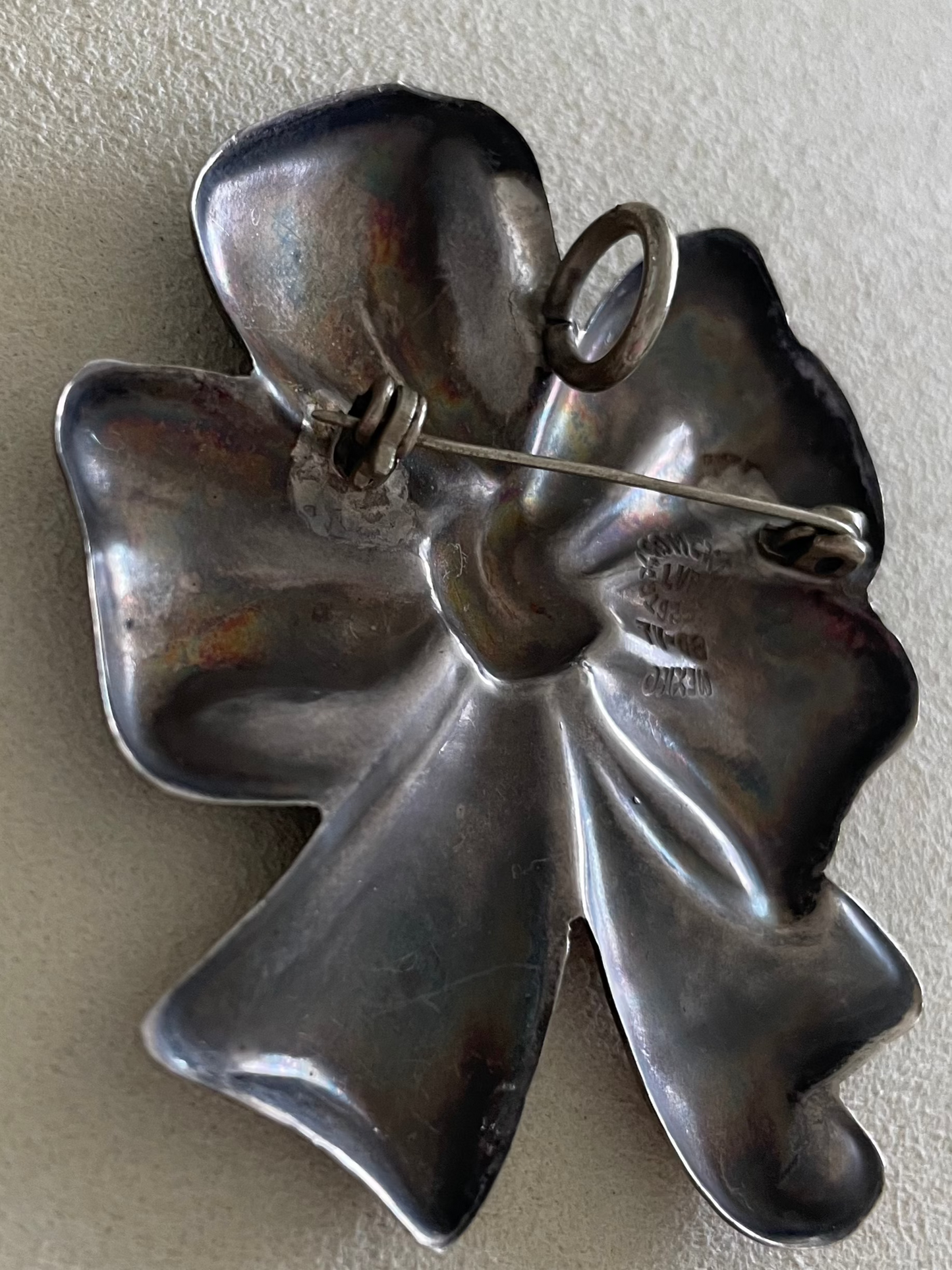 Large estate Mexican sterling silver puffy bow brooch pin pendant with mirror finish, displayed on pink cord necklace