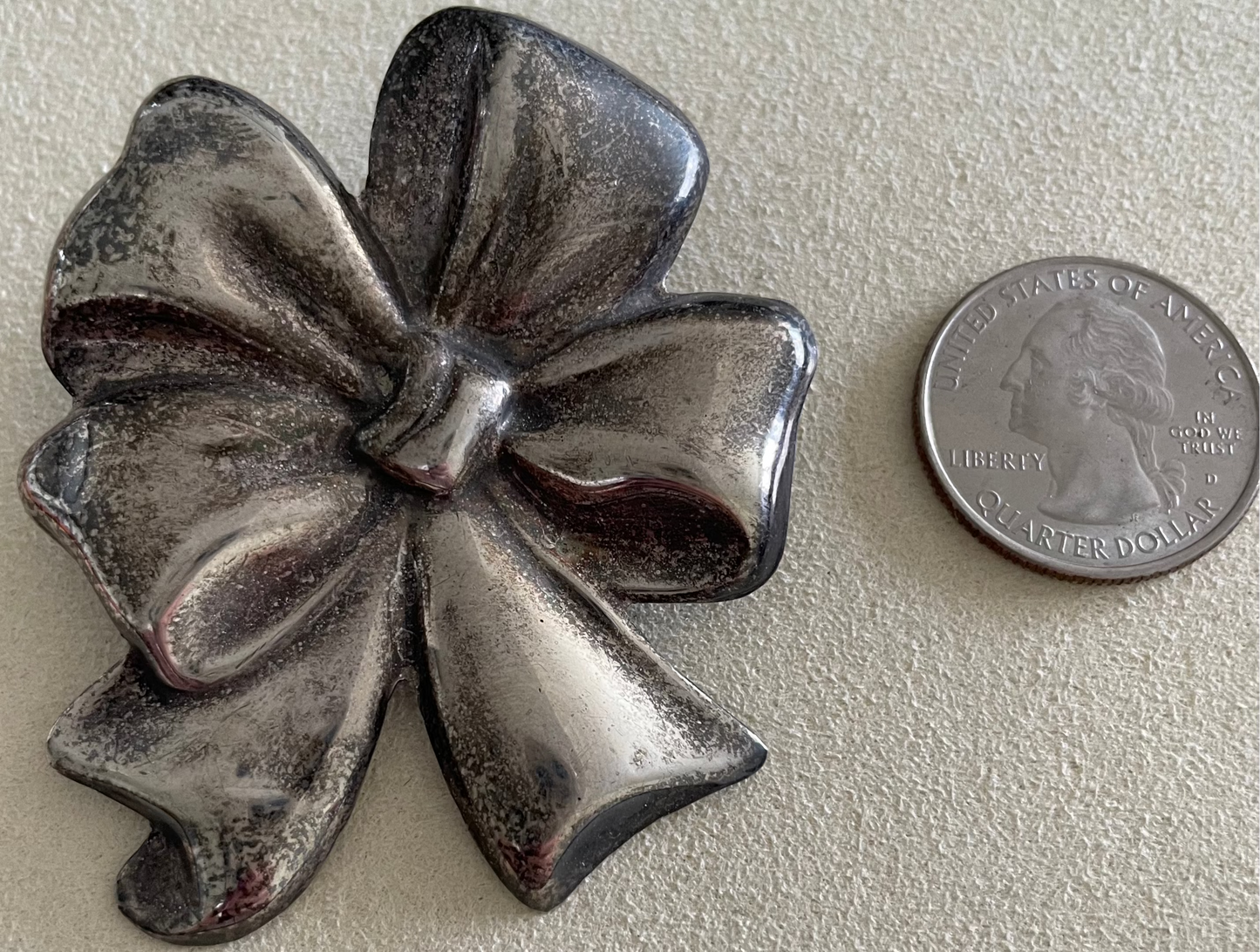 Large estate Mexican sterling silver puffy bow brooch pin pendant with mirror finish, displayed on pink cord necklace