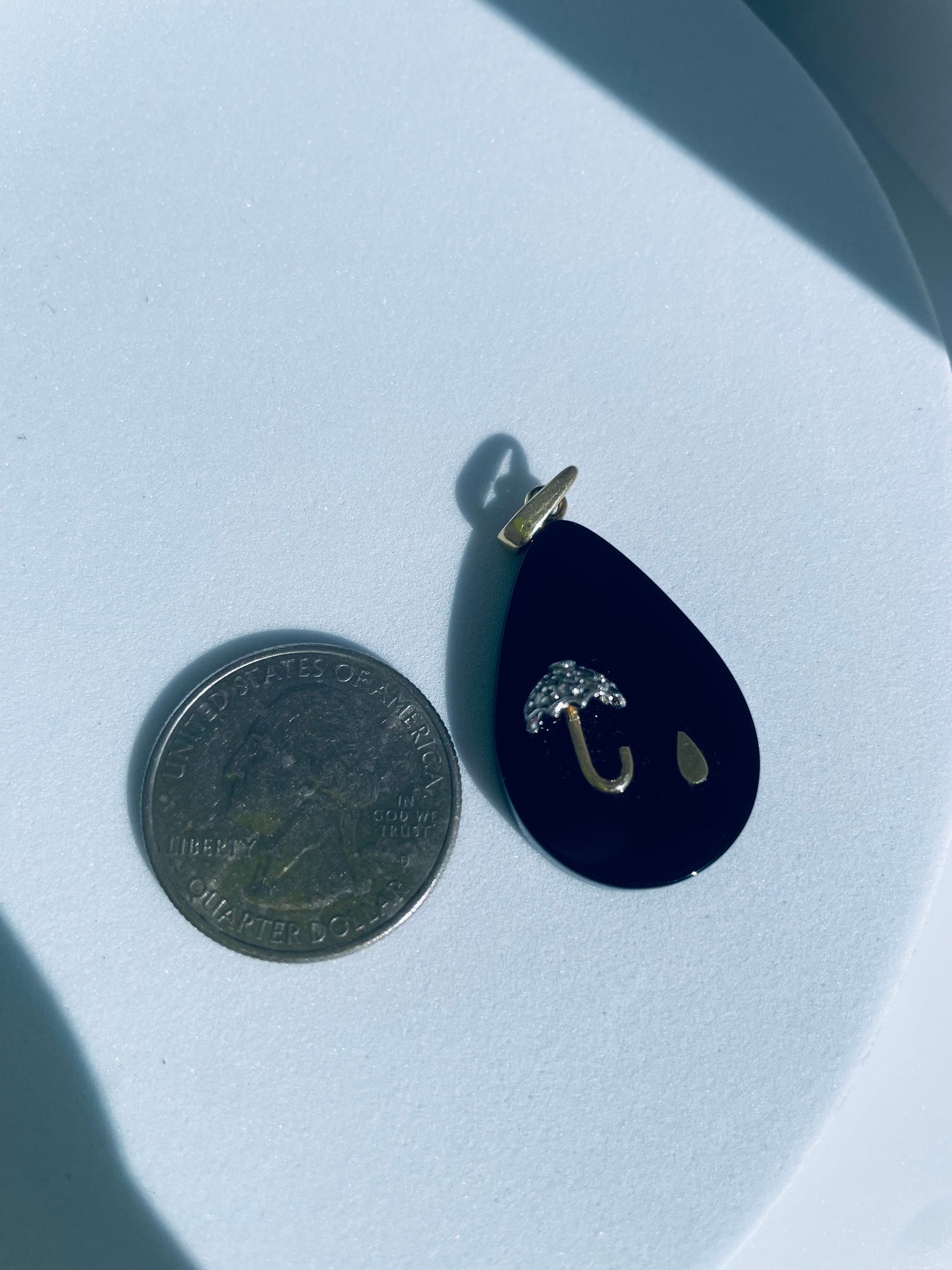 Estate 14K gold black onyx teardrop pendant with inlaid umbrella and raindrop design, diamond accent, 1980s whimsical jewelry