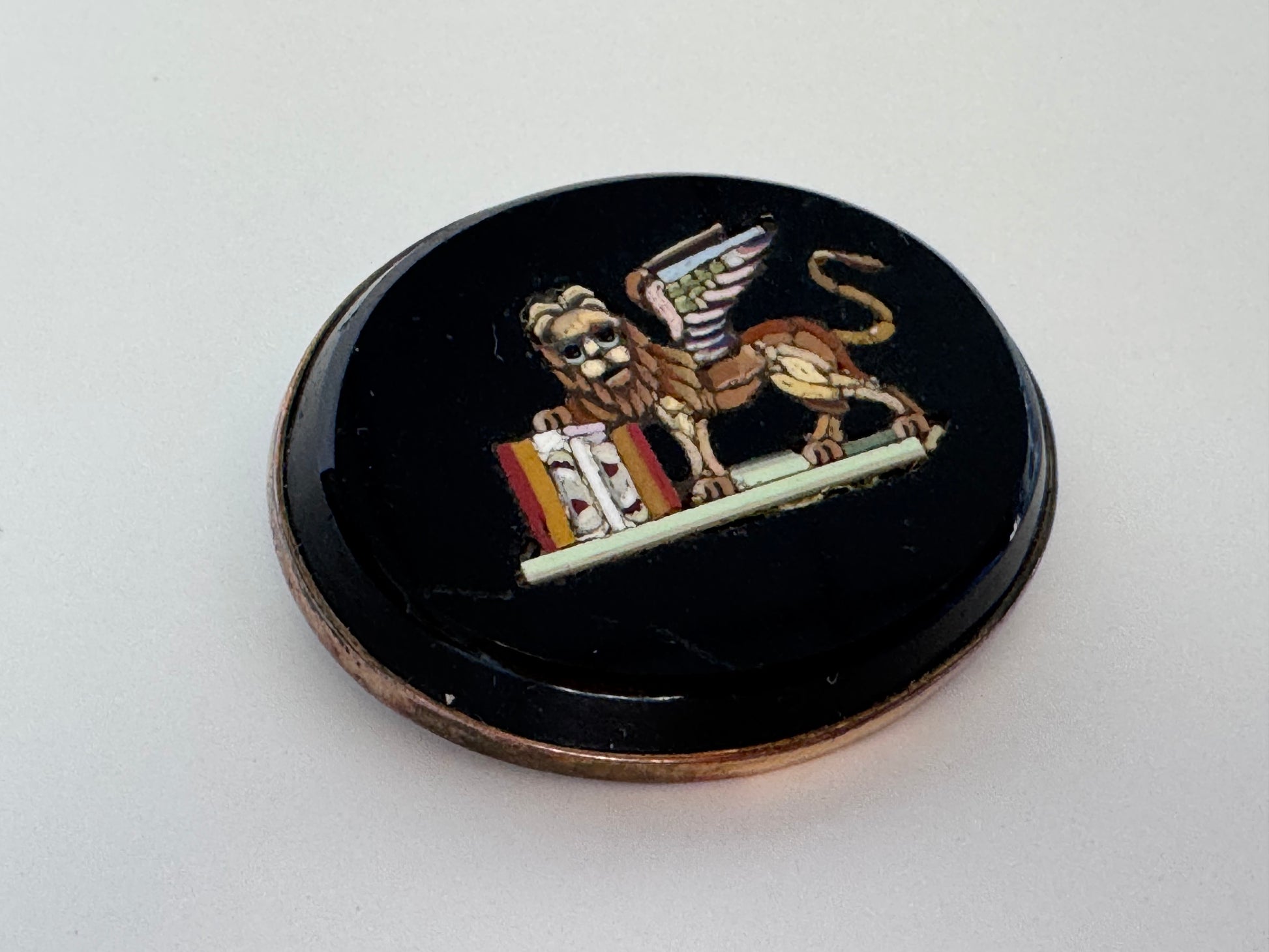 Antique sterling silver micro mosaic brooch featuring winged Lion of St. Mark in colorful glass tesserae on black background, Venetian Grand Tour souvenir jewelry