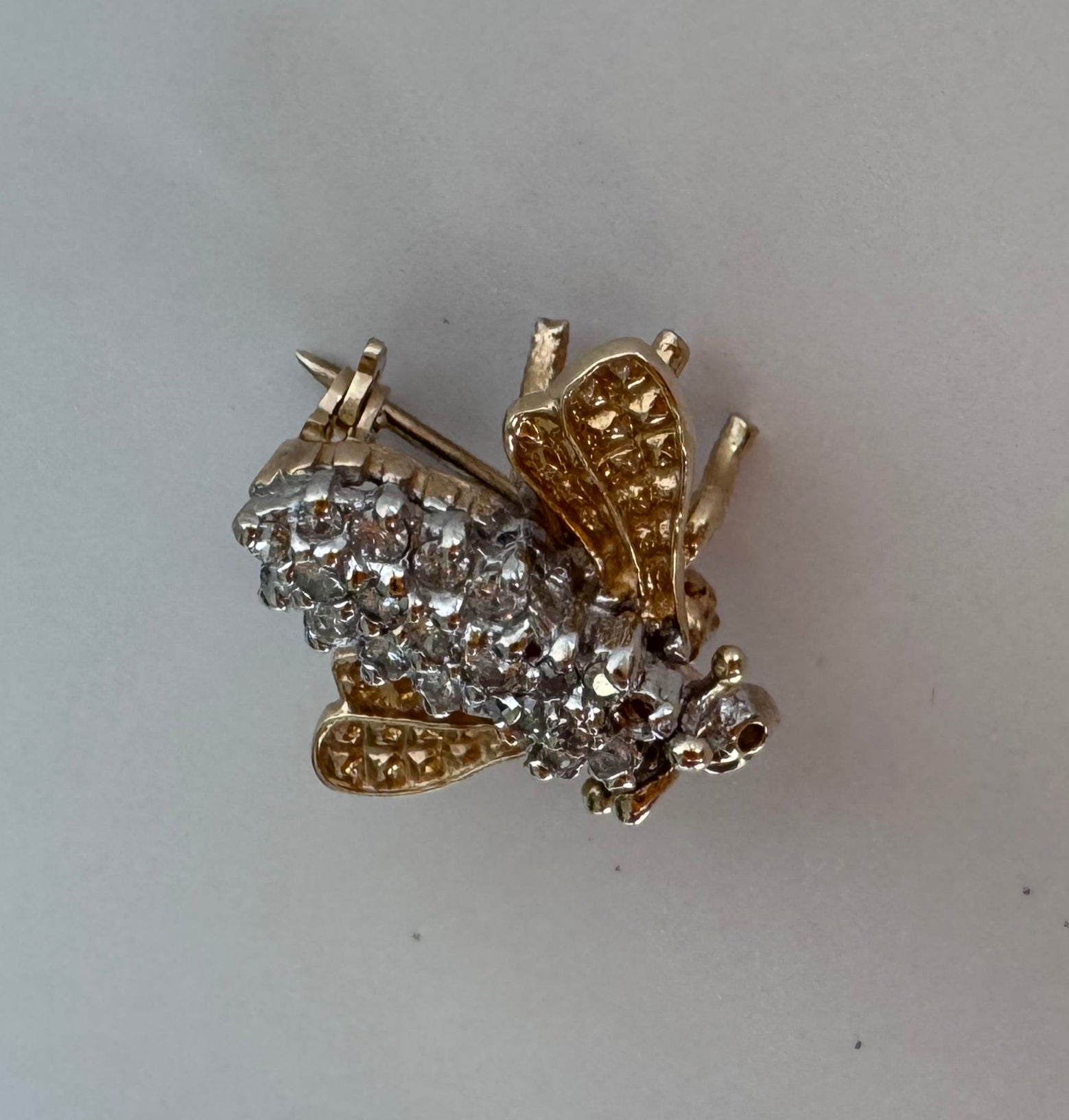 Estate 14K gold bee brooch with diamond-encrusted body and textured wings, vintage insect pin jewelry