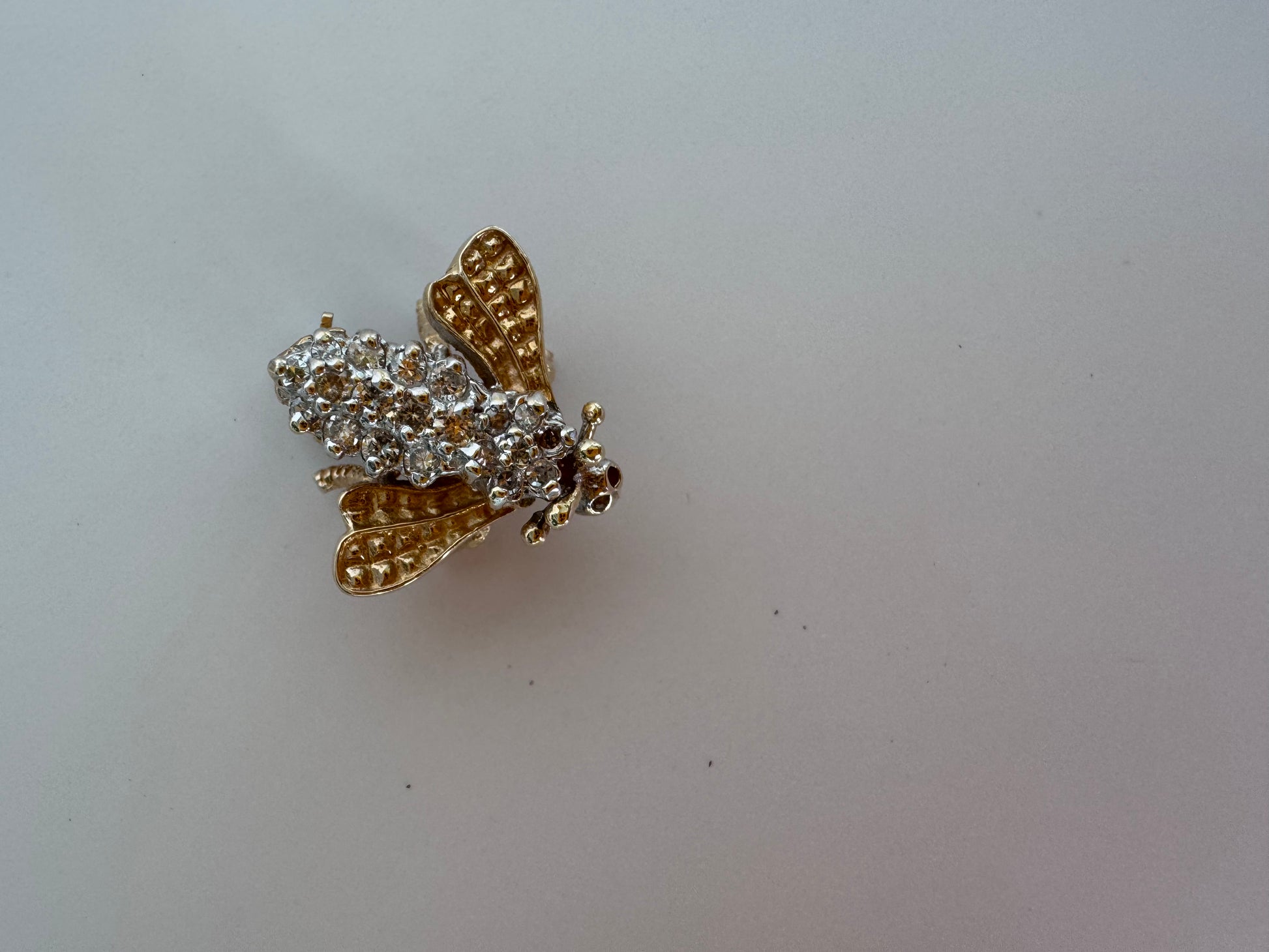 Estate 14K gold bee brooch with diamond-encrusted body and textured wings, vintage insect pin jewelry