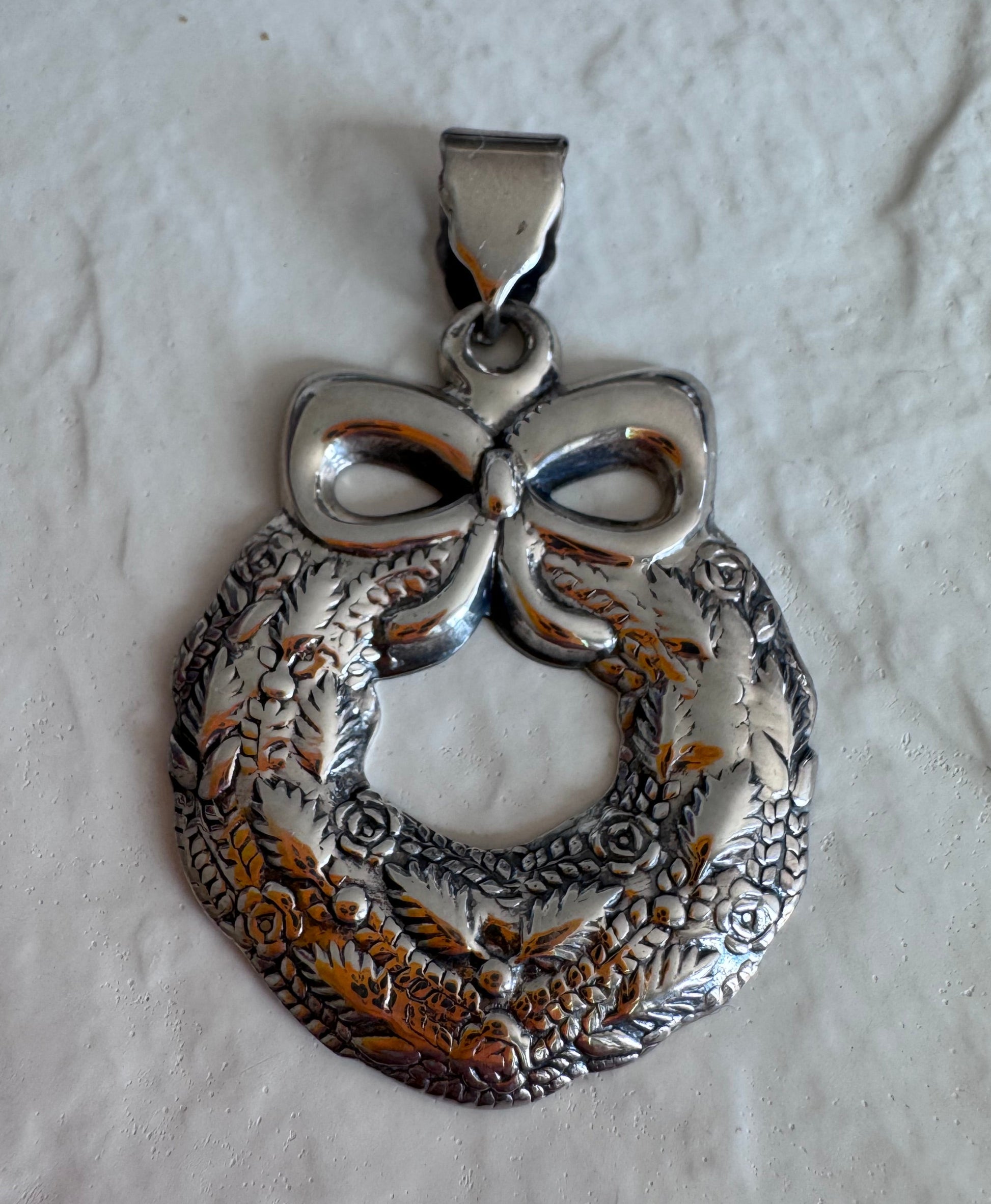 Estate 925 sterling silver Christmas wreath pendant from Thailand with detailed roses leaves and bow showing intricate Thai craftsmanship