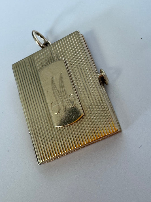 Vintage 14K gold book locket with hinged pages, engine-turned texture, engraved details, multiple photo compartments