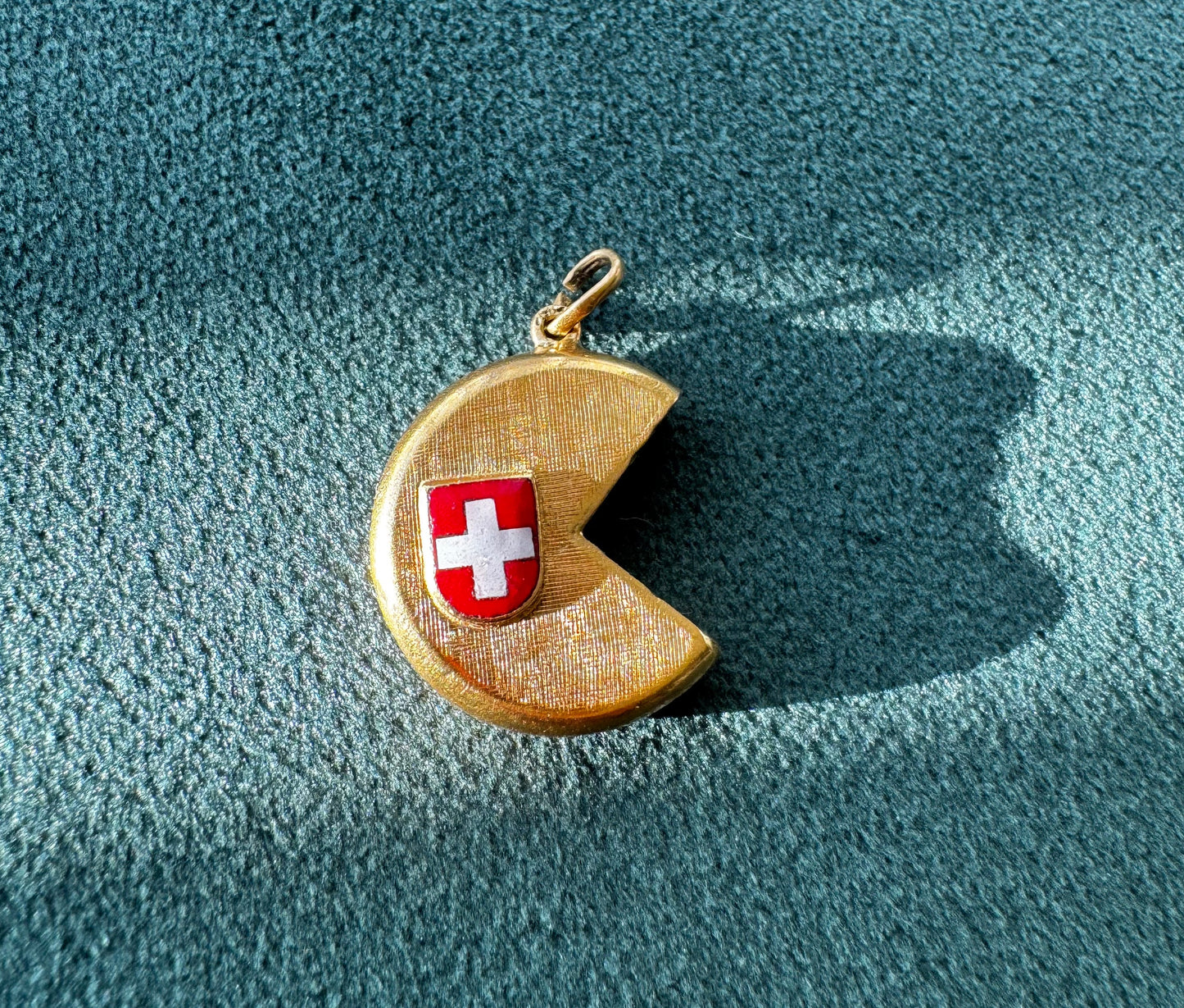 Vintage 18K gold Swiss cheese wheel charm with slice cut out and red white enamel Swiss flag shield