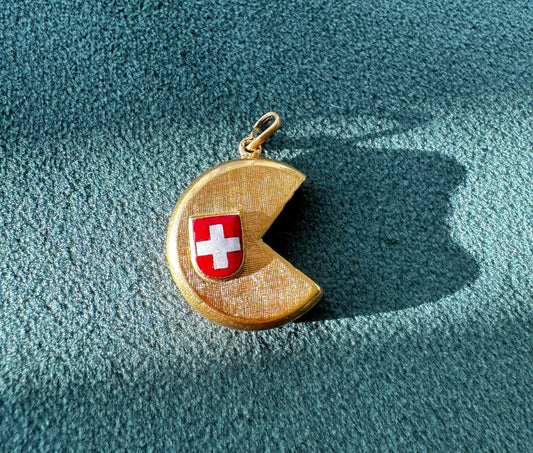 Vintage 18K gold Swiss cheese wheel charm with slice cut out and red white enamel Swiss flag shield