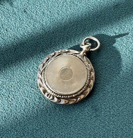 Antique 14K gold round locket with engine turned guilloche pattern and ornate border, original Victorian photo inside
