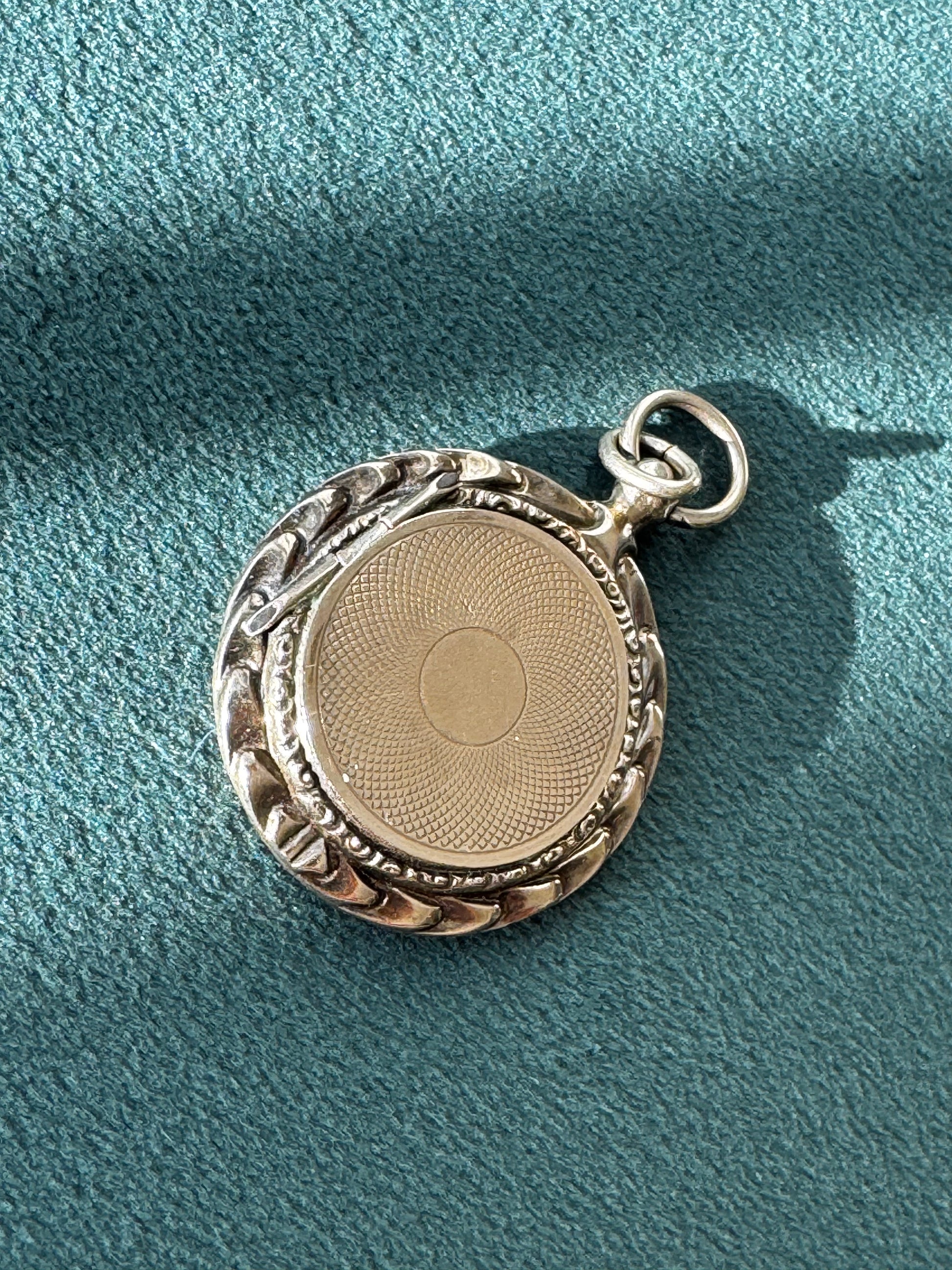 Antique 14K gold round locket with engine turned pattern and ornate border, original Victorian photo inside